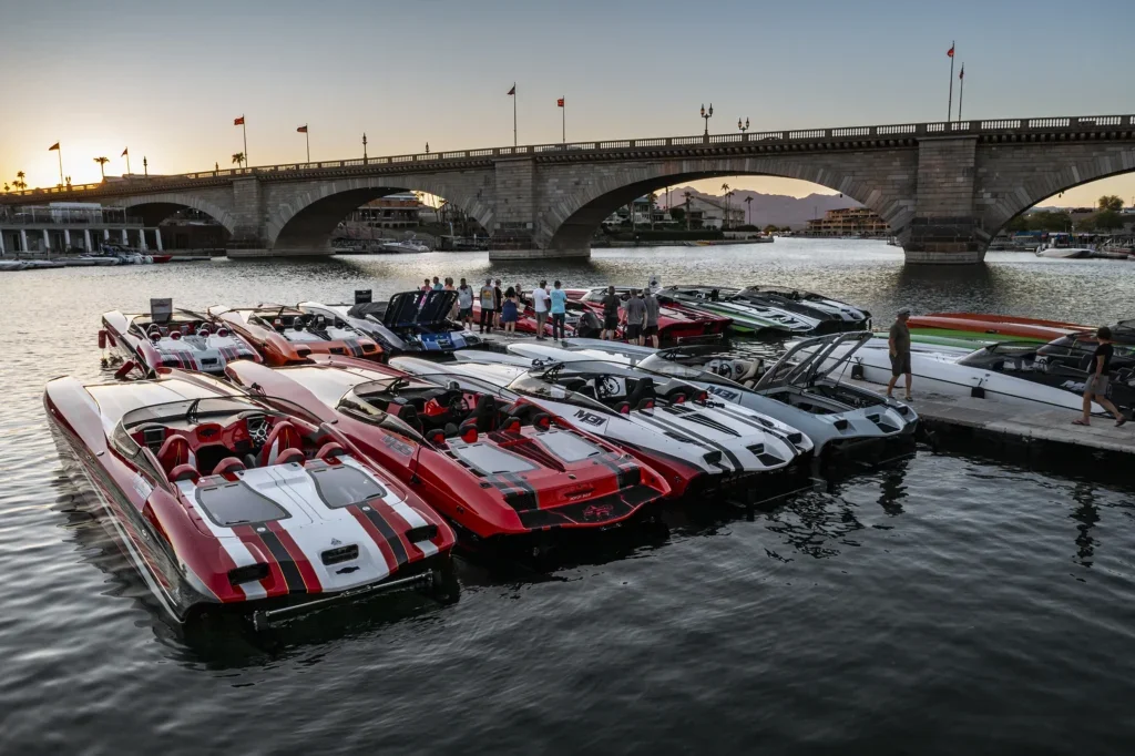 DCB boat lined up on the dock in the foreground; Lake Havasu's London Bridge in the background