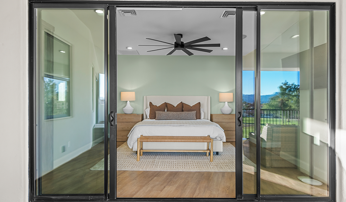 An indoor-outdoor view of one of the primary bedrooms in a Havasu Lux Stays vacation rental