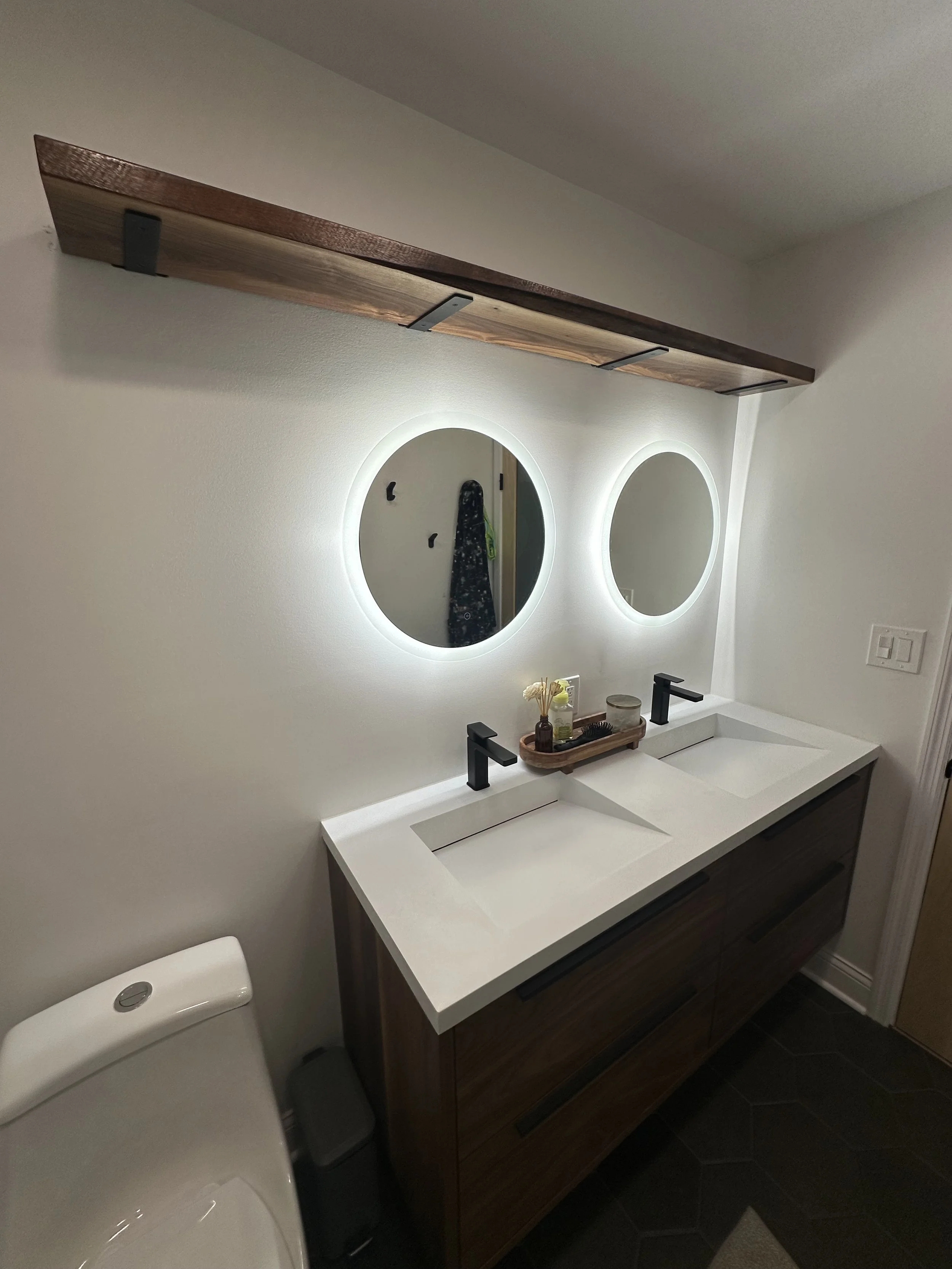Live edge shelf in first floor bathroom. Measured, cut down, planed, sanded, stained, and accurately installed shelf brackets and shelf. 