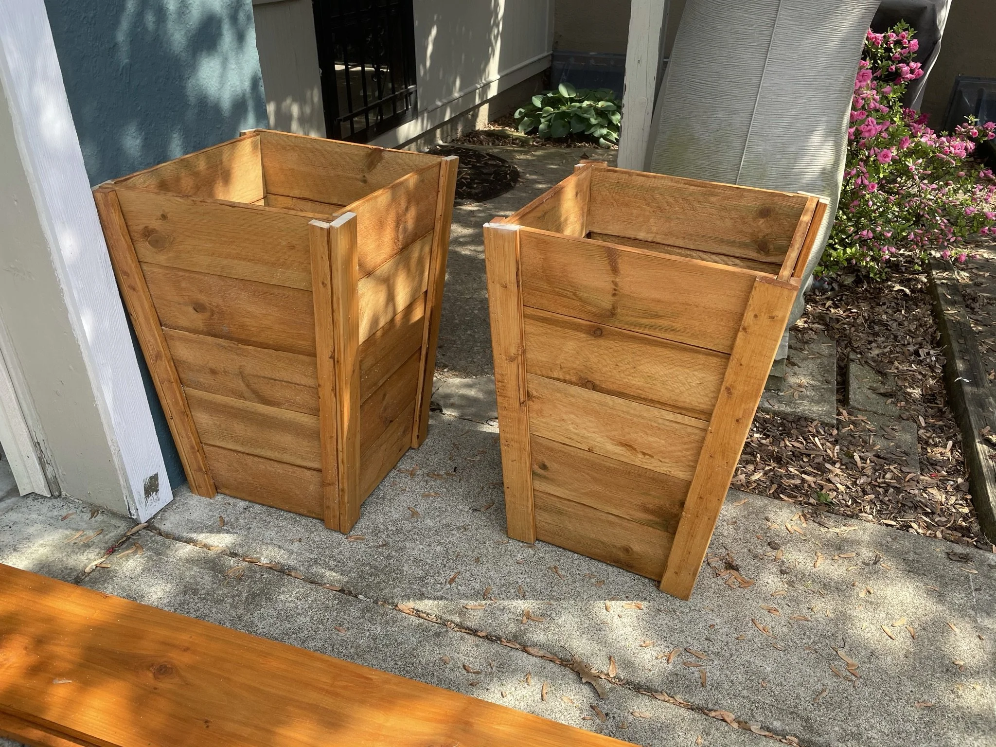 Planter boxes we built from cedar fence planks and then stained and placed around our house. 