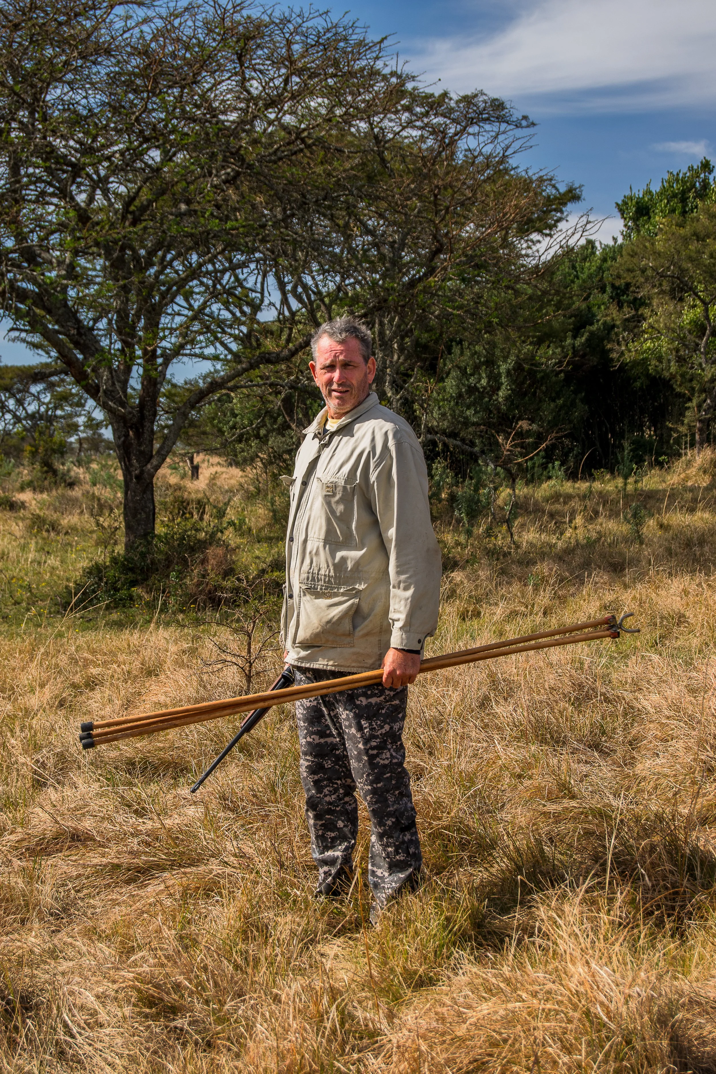 Subsistence hunter posed with rifle (Winchester 243) and shooting sticks