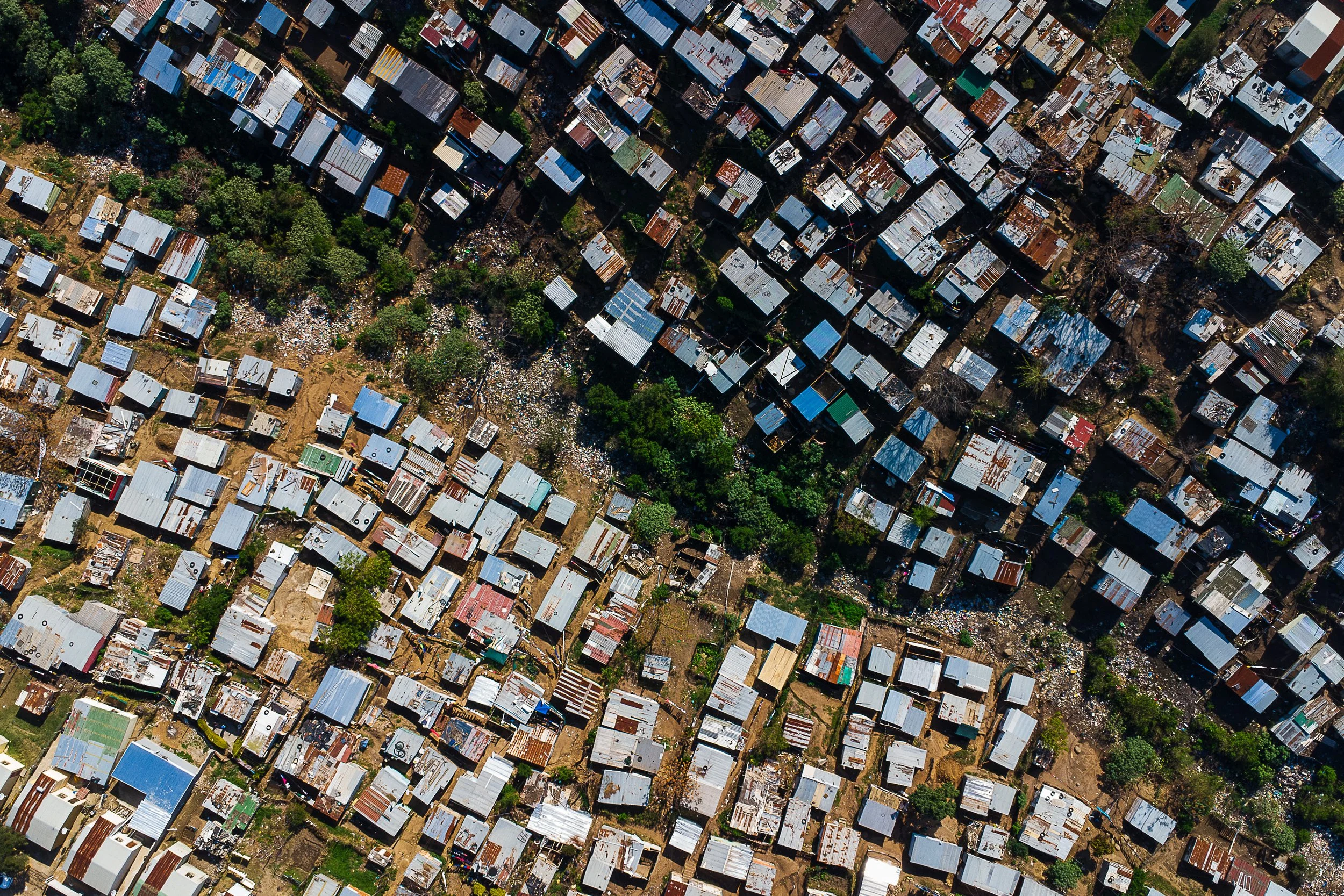 Aerial shot of the Gopppas township with an old riverbed running through the middle filled with waste