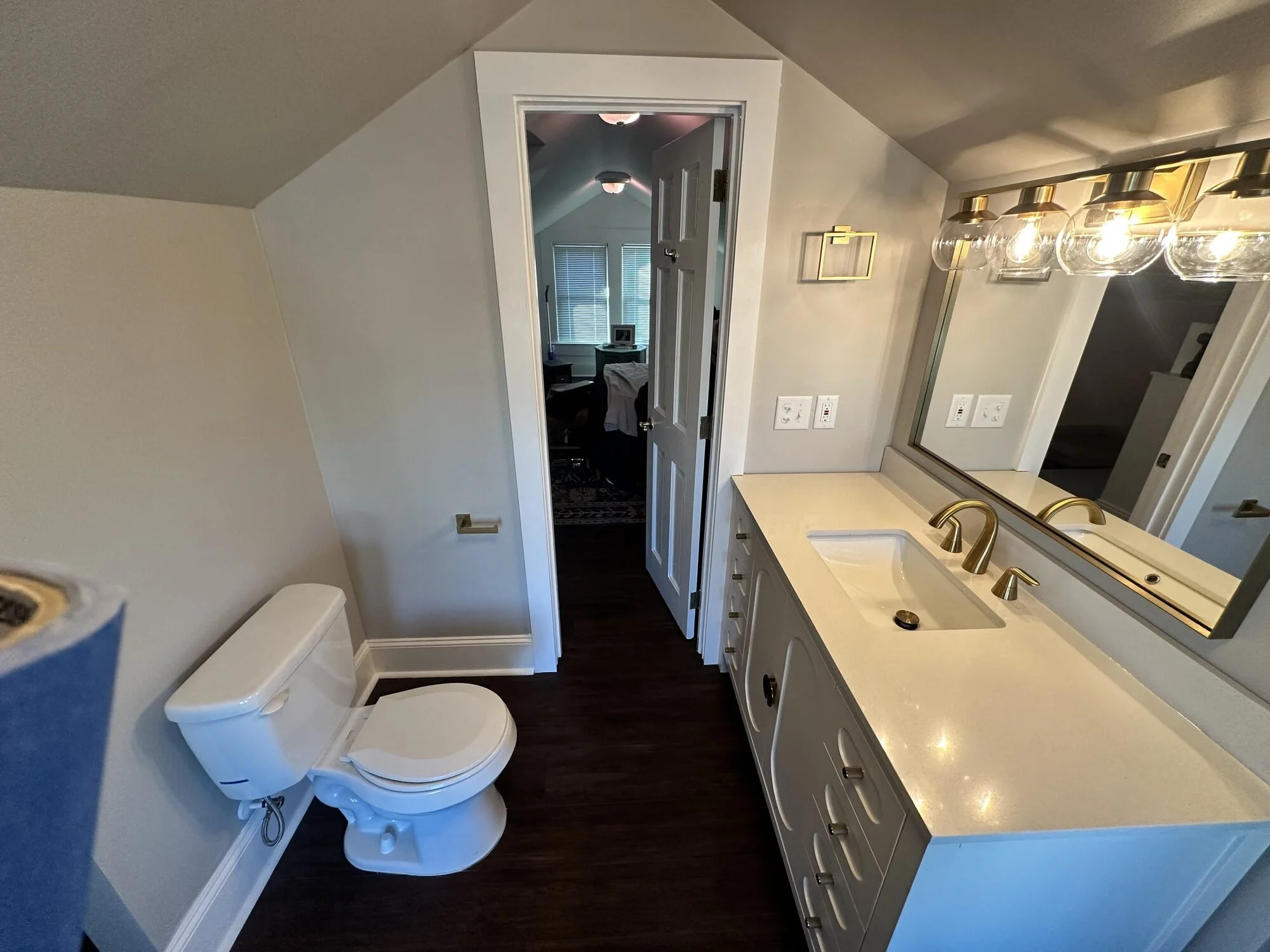 After — new toilet and vanity along the knee wall, making full use of the attic footprint