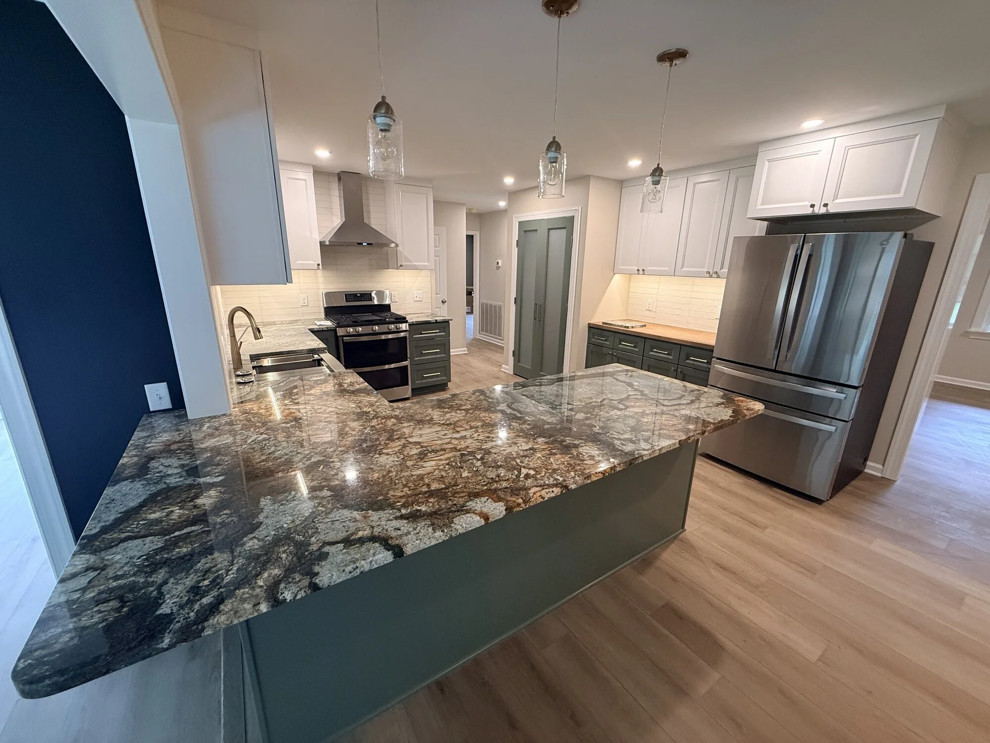 After — the full kitchen opened up, peninsula anchoring the space