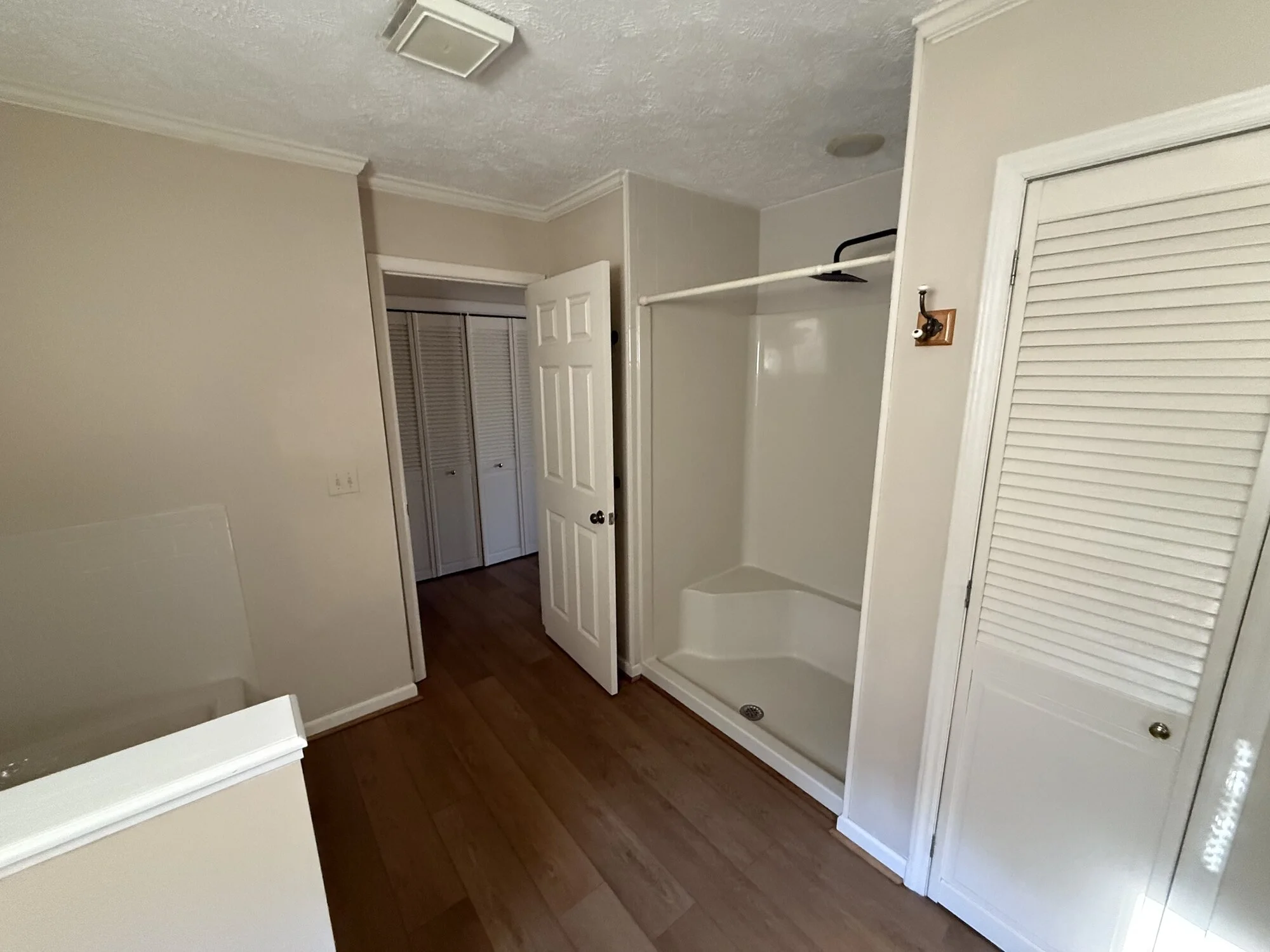 Before — the cramped original layout, shower stall wedged between closets