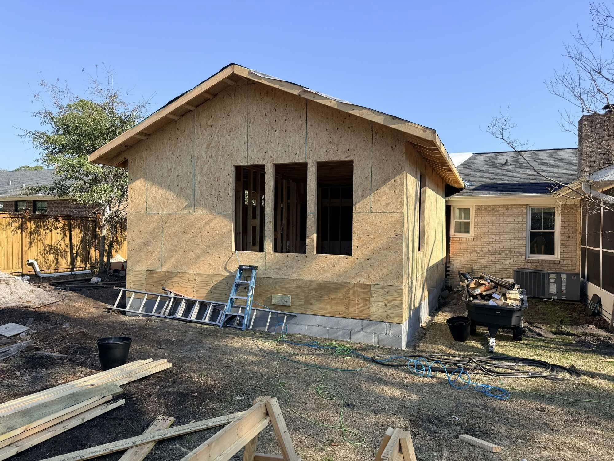 During — the addition framed and sheathed with window openings cut