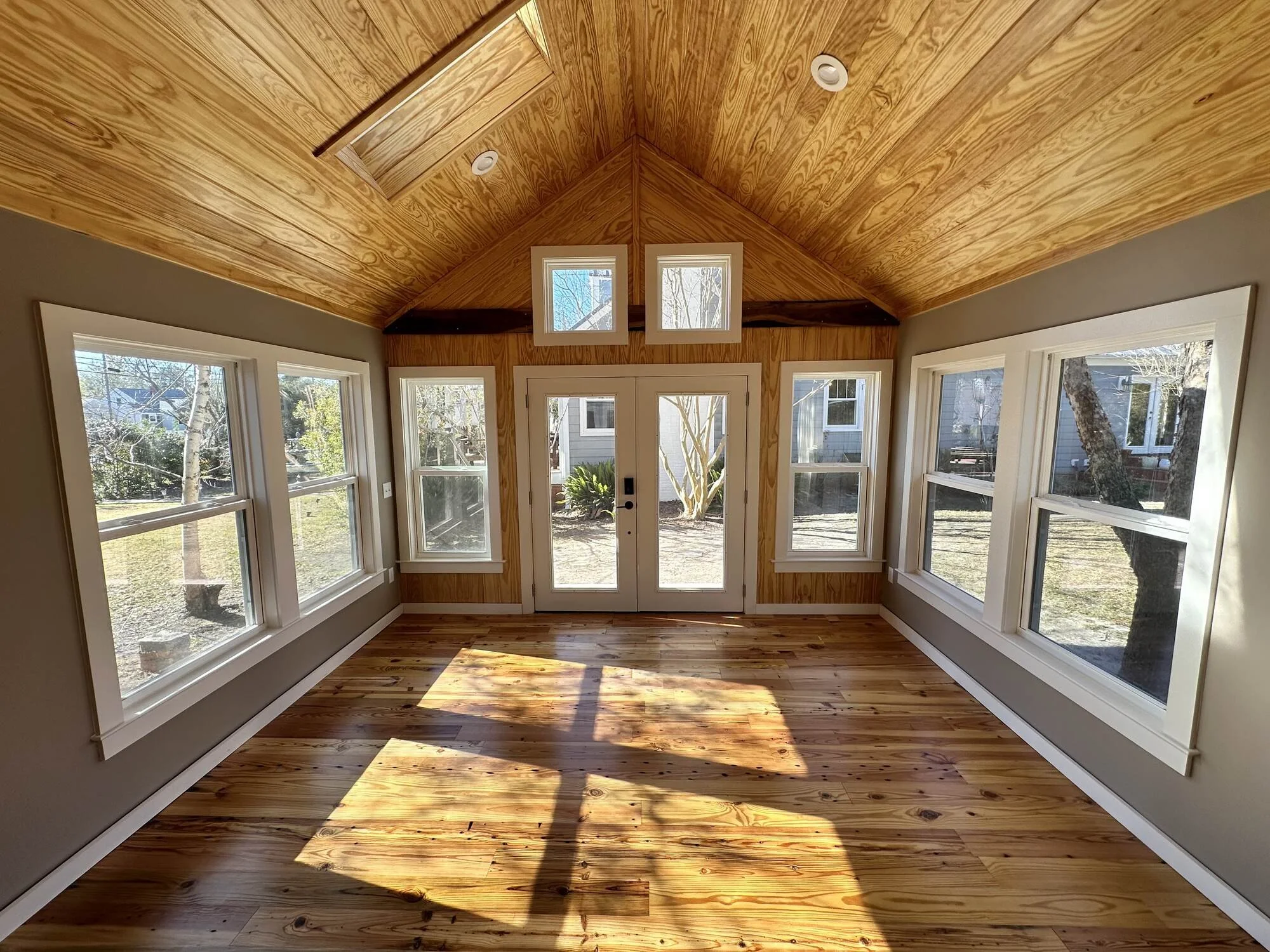 Studio interior with French doors, transom windows, and finished wood floors — Central Blvd, Wilmington NC