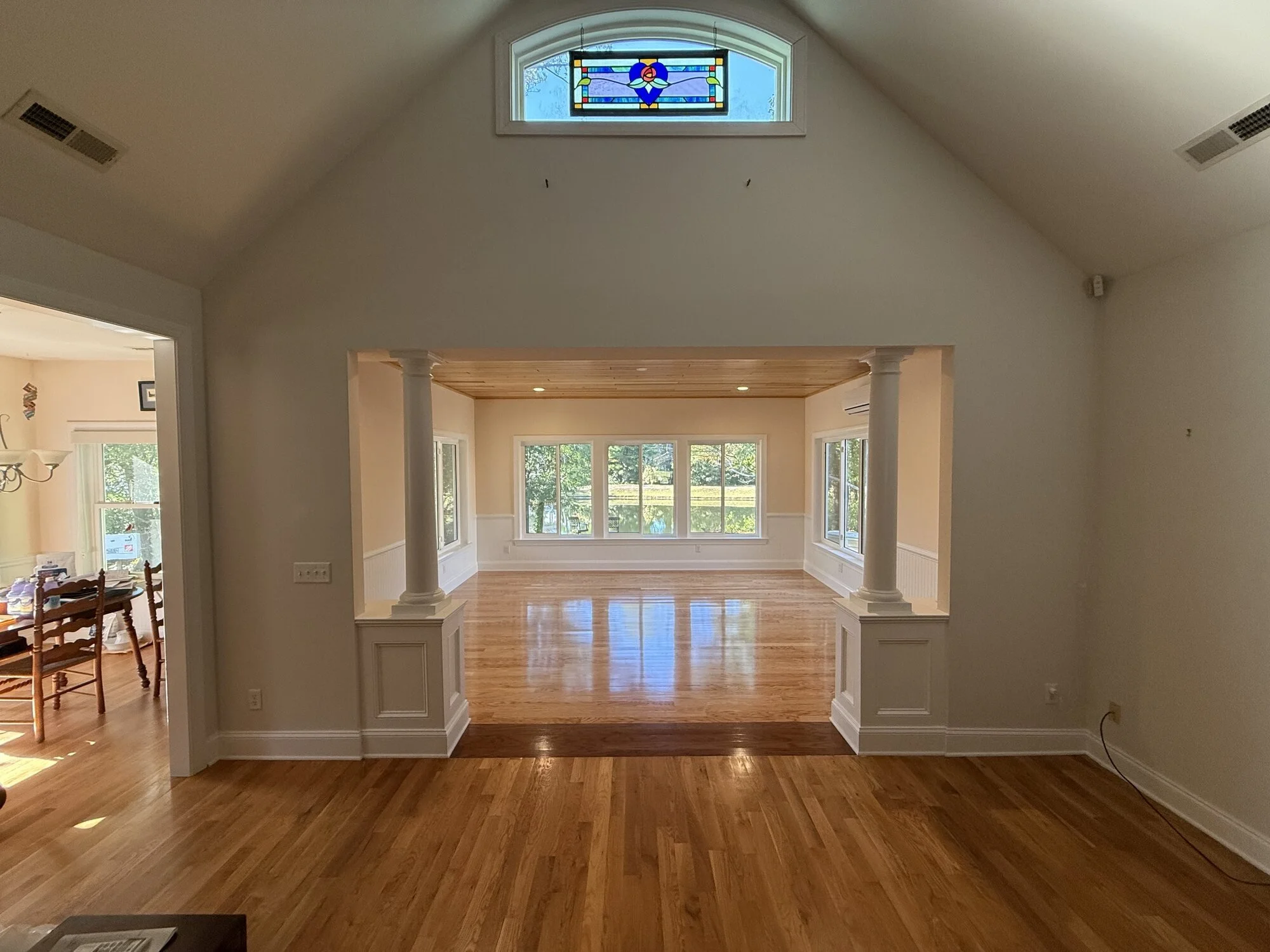After — the columned opening into the new sunroom, pond views beyond