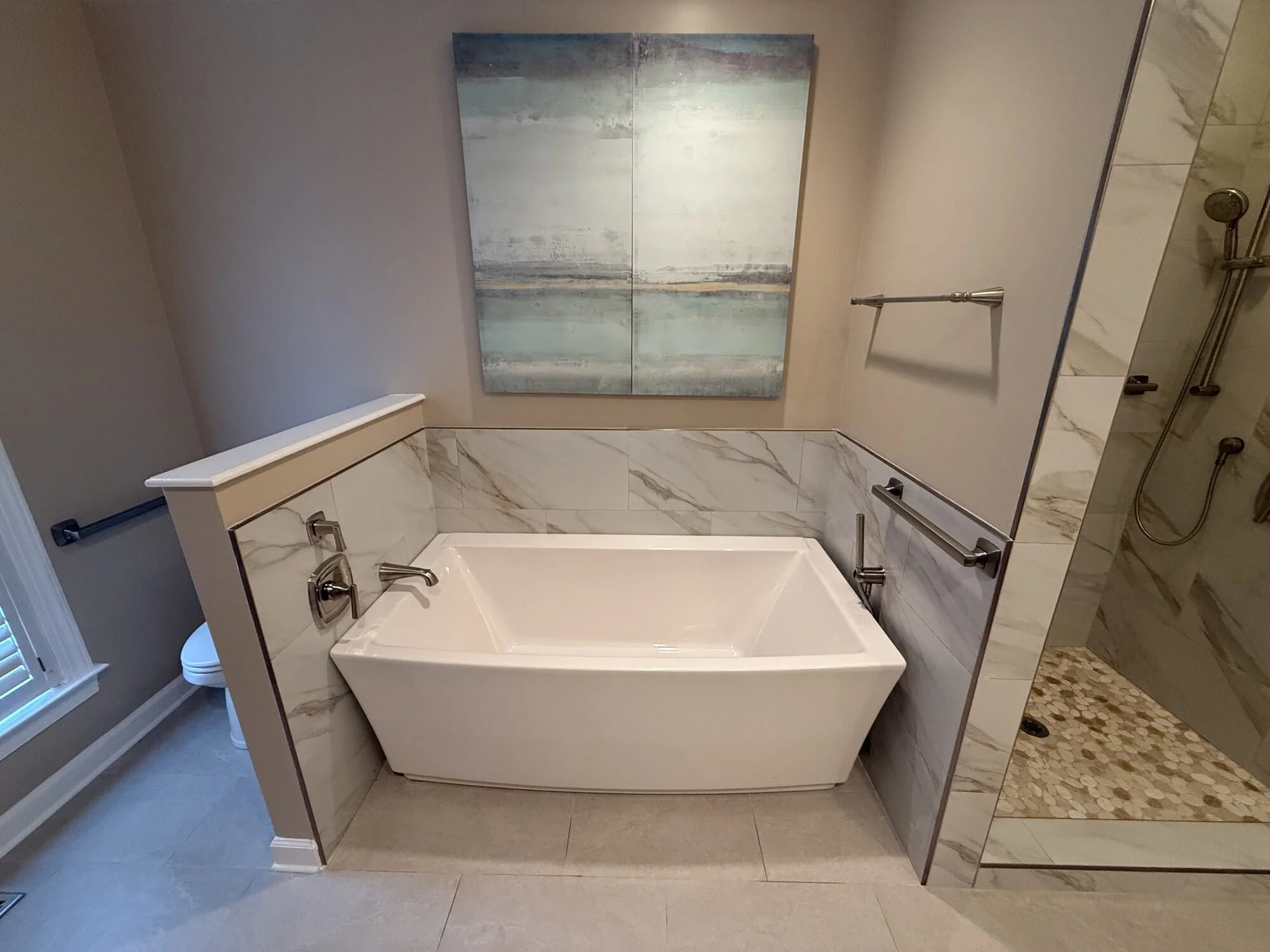 After — soaking tub detail with tile surround and natural light
