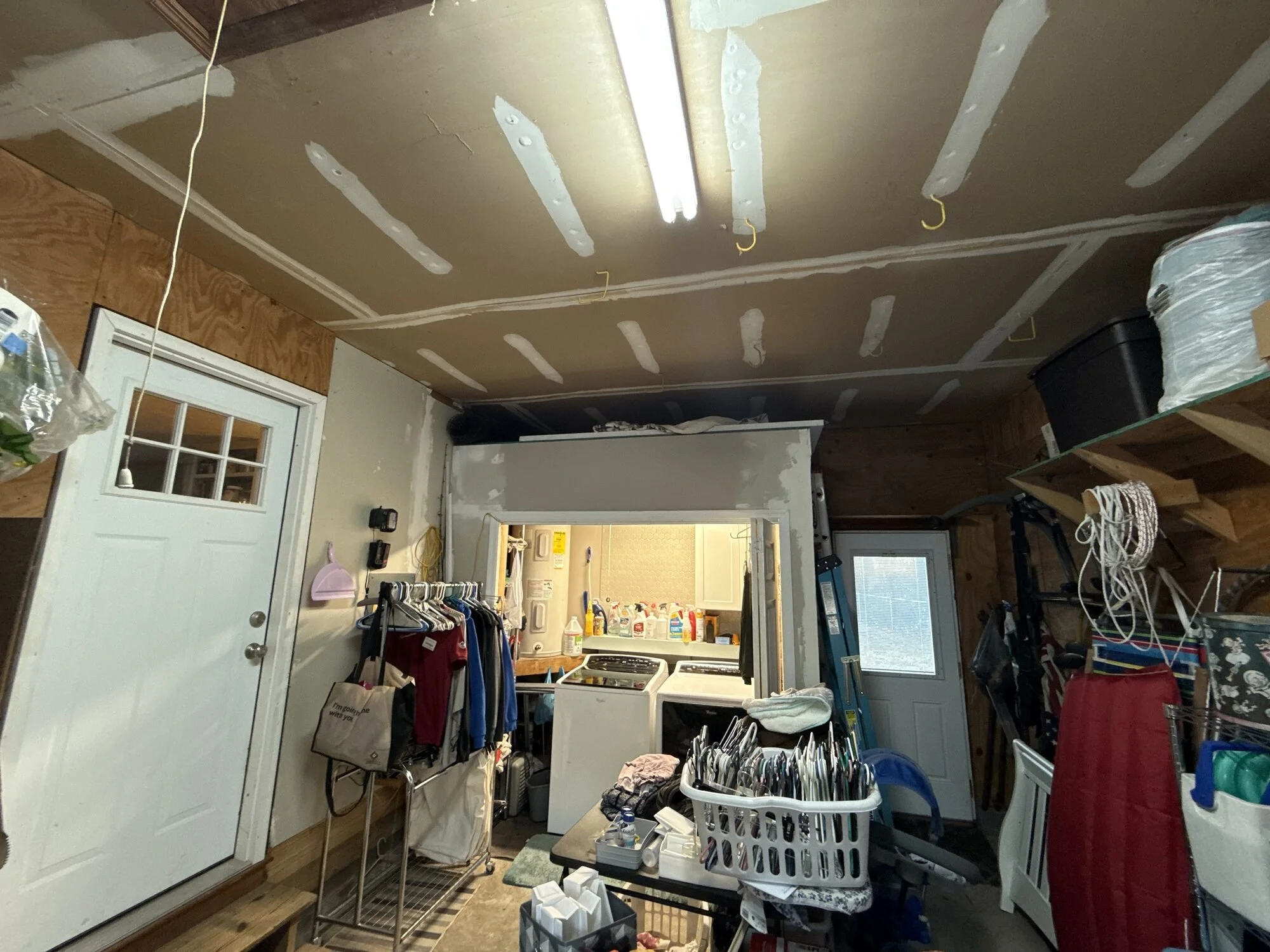 Before — garage workbench and old unfinished ceiling before the build-out