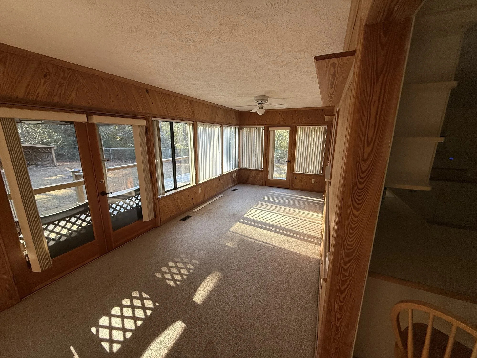 Before — another view of the dark, wood-paneled sunroom