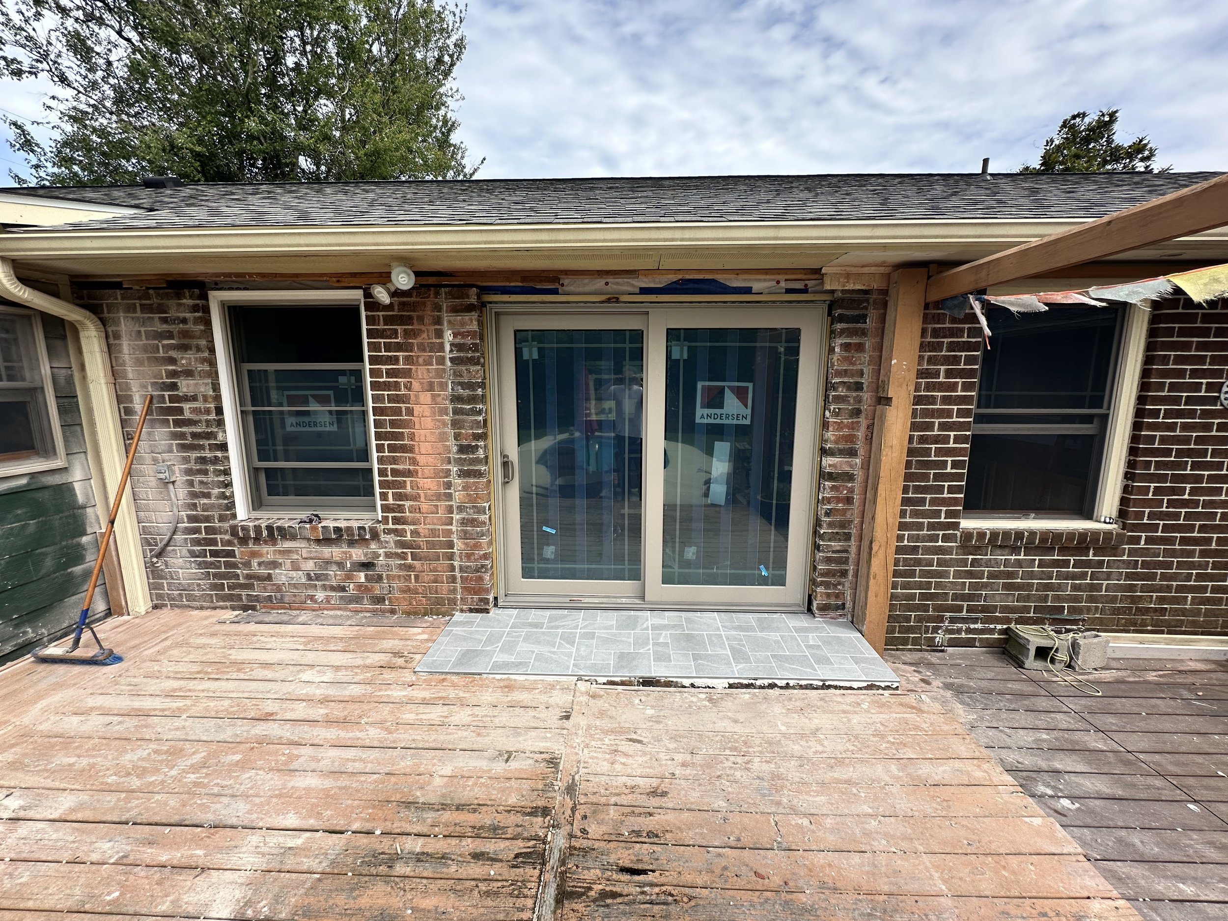 Removed fireplace and back walk through door, replaced with sliding door and window