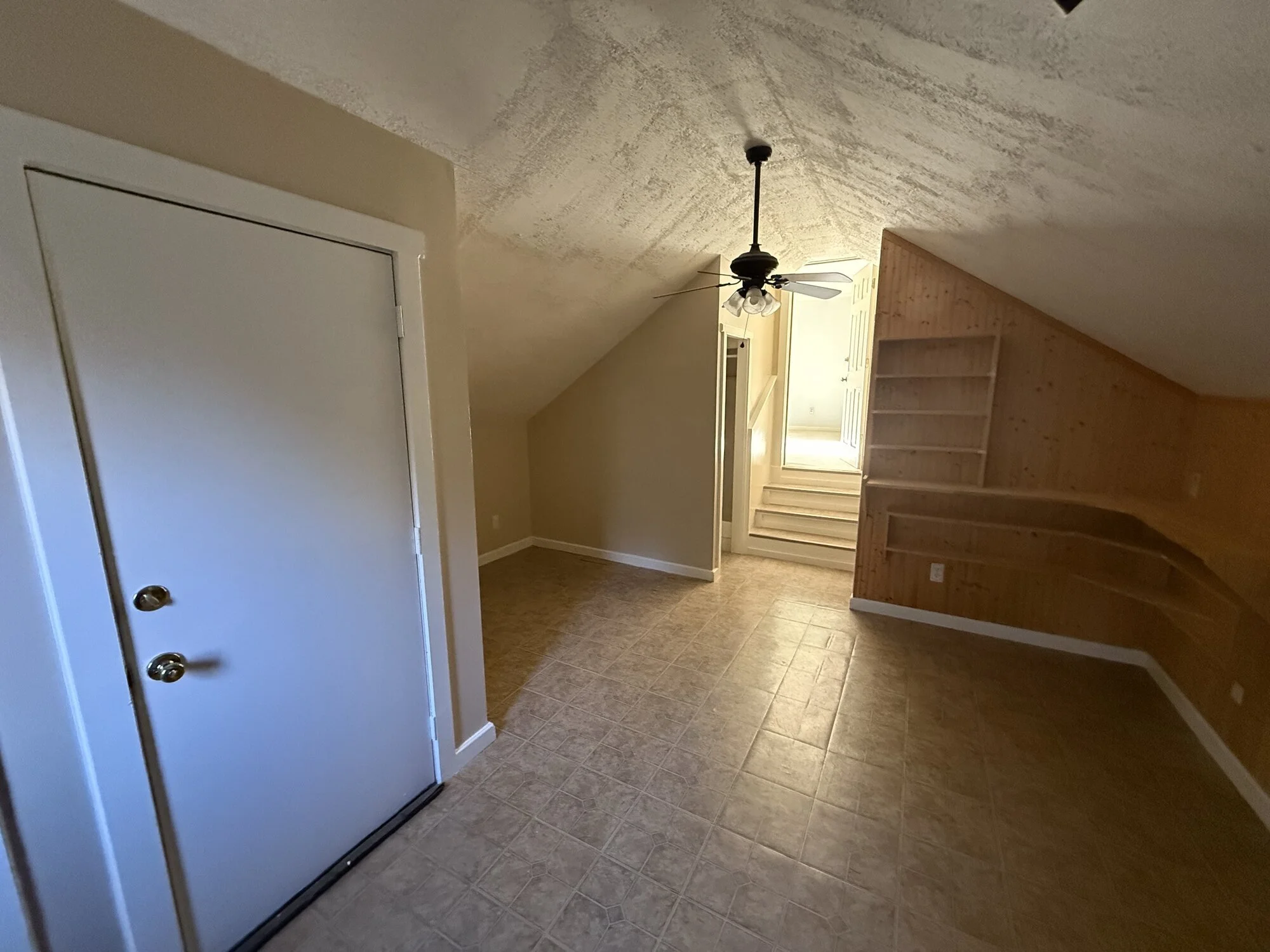 Before — old built-in desk and cabinets in the bonus room before demo