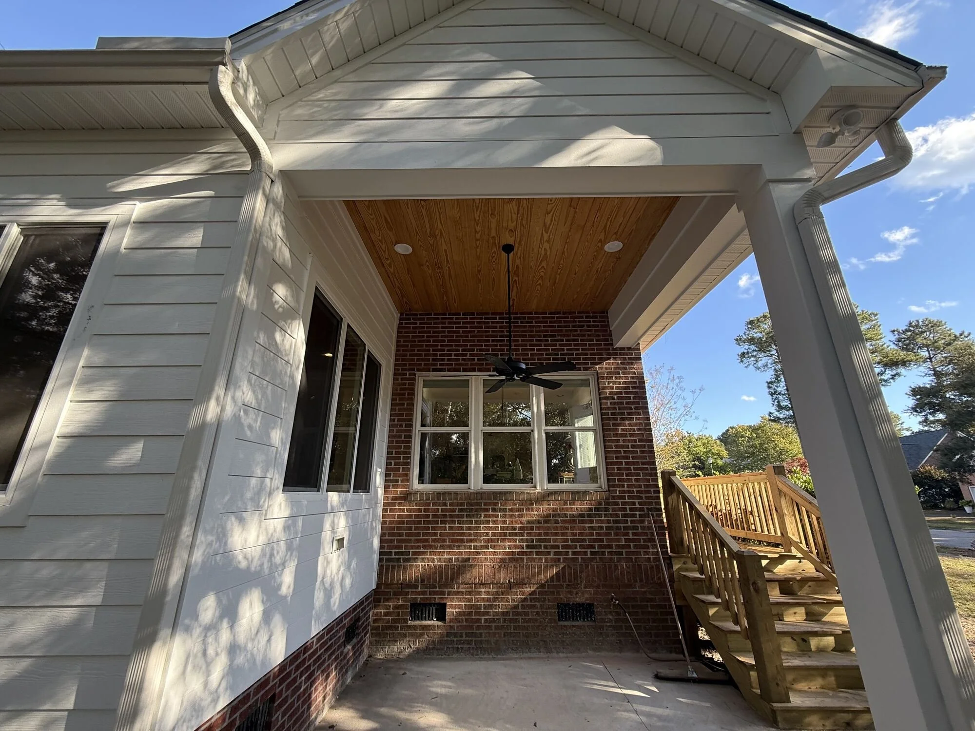 After — covered porch with tongue-and-groove pine ceiling and fan