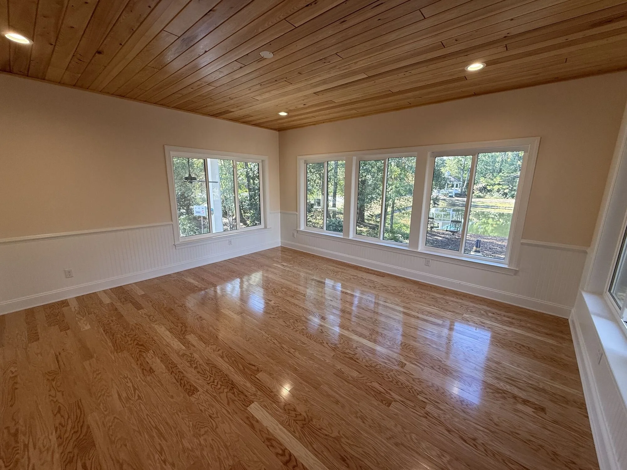 After — corner windows framing the pond and gazebo views