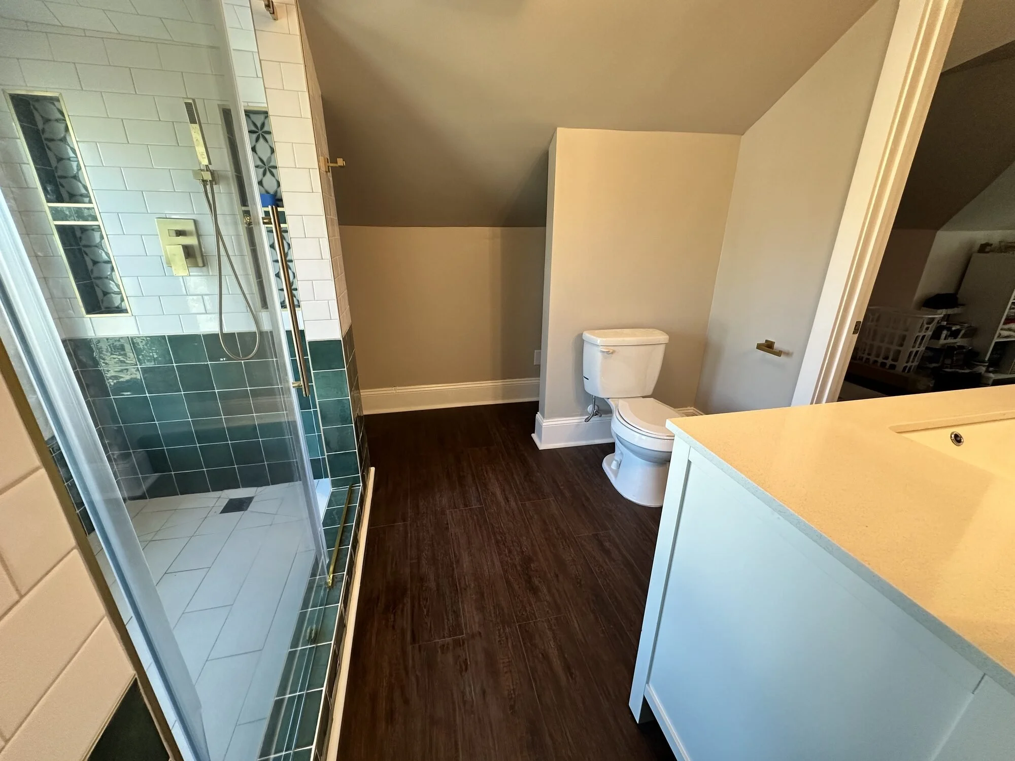 After — the finished attic bath, with the walk-in shower tucked neatly under the original roofline