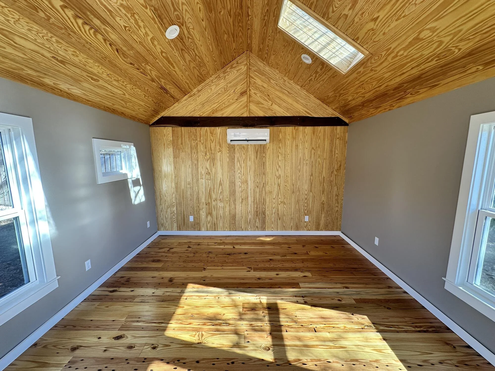 Tongue-and-groove wood ceiling, accent wall, and skylight inside the finished studio on Central Blvd, Wilmington NC