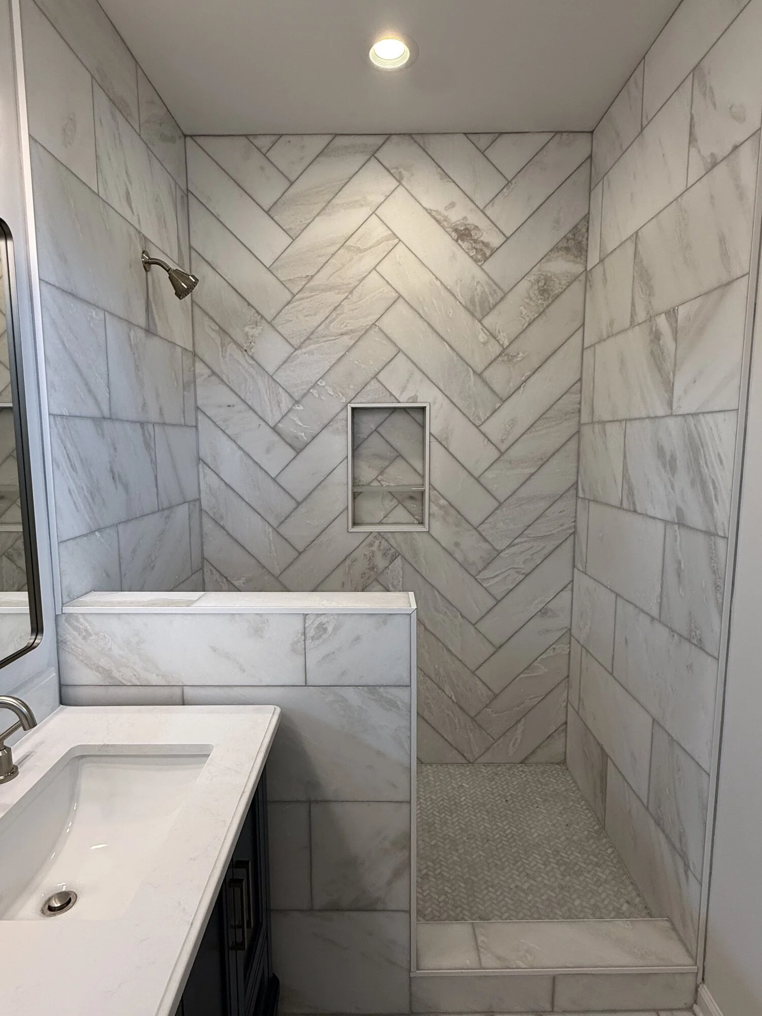 After — elegant walk in shower against floor-to-ceiling tile
