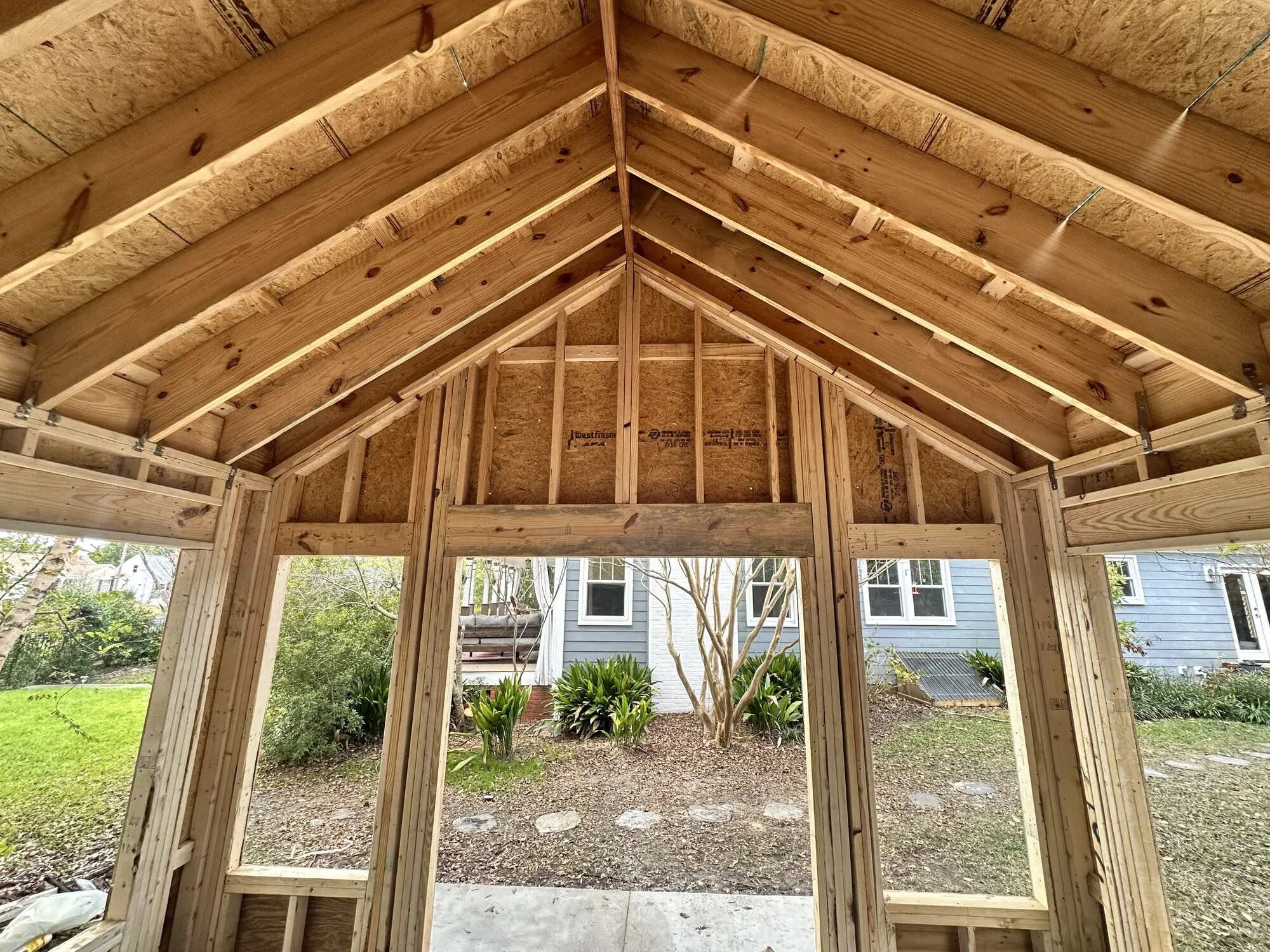 Vaulted rafters and window framing inside the Central Blvd studio build in Wilmington, NC
