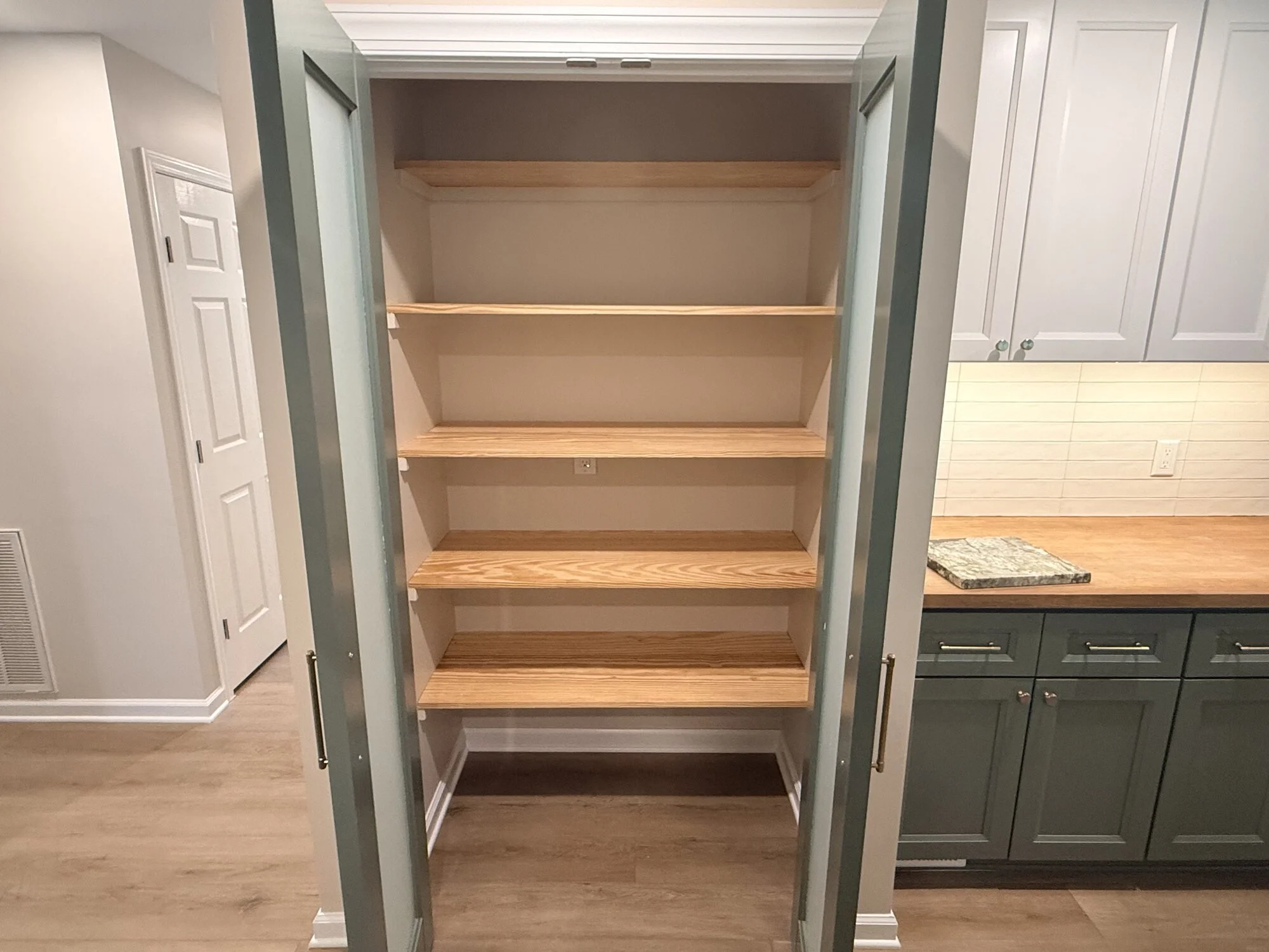 After — custom pull-out pantry with adjustable shelving