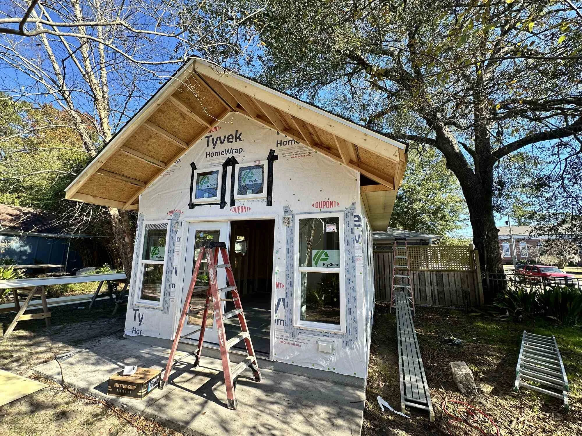 Studio exterior taking shape — windows set and cedar shake gable installed on Central Blvd in Wilmington, NC