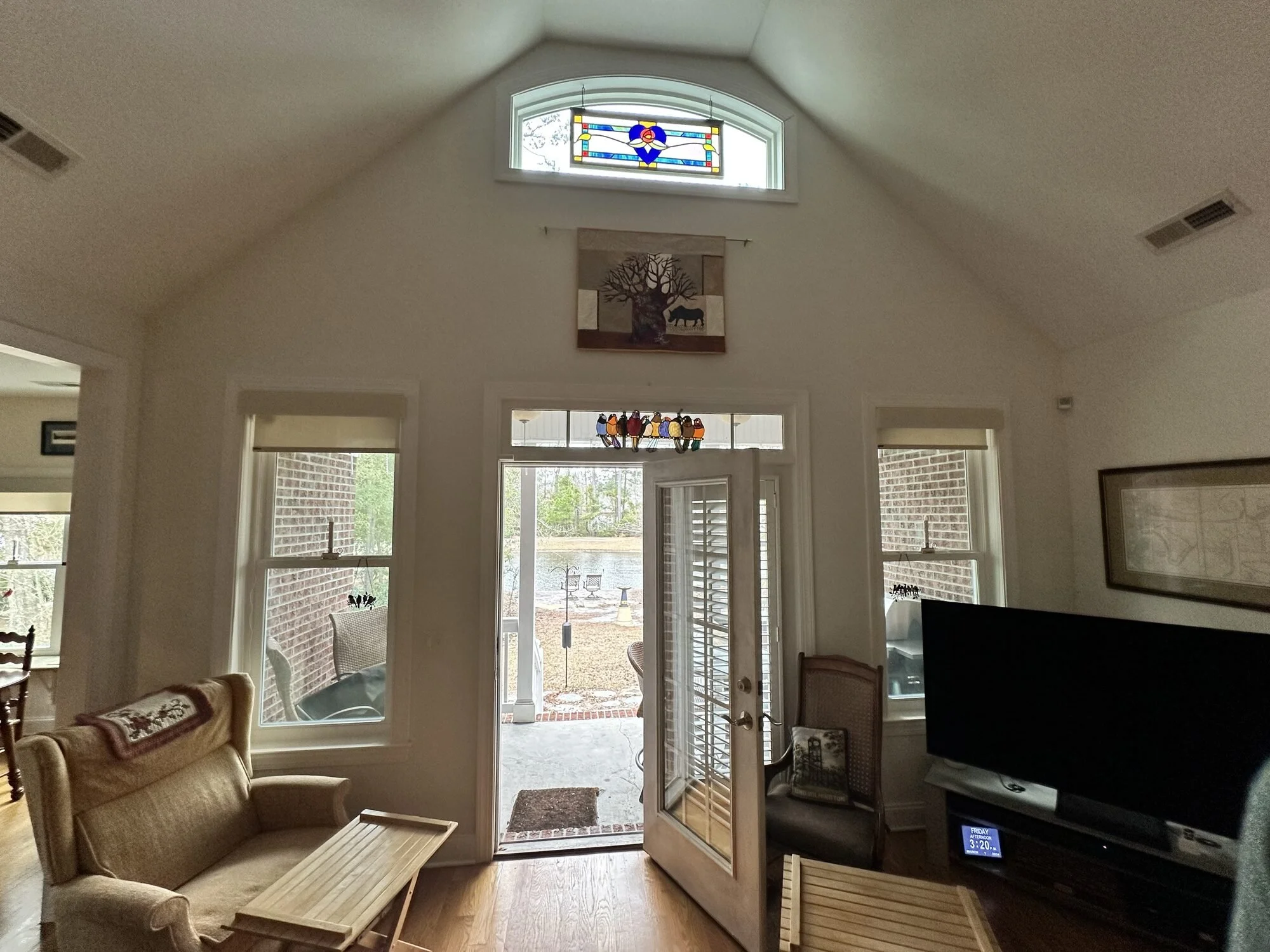 Before — the original view from the living room with French doors to the back porch and stained glass transom