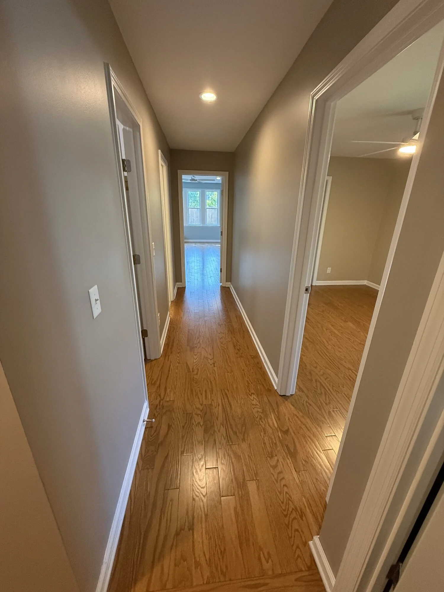 After — the finished entry to the suite with natural light and hardwoods