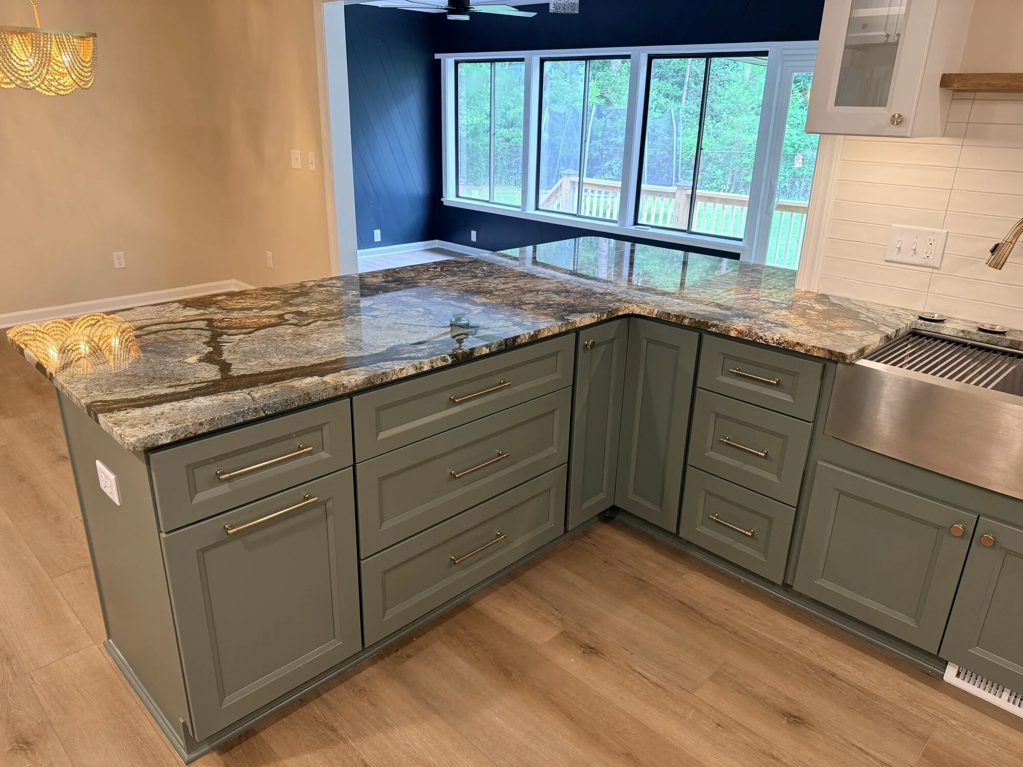 After — granite wrapping the corner in front of the family room beyond