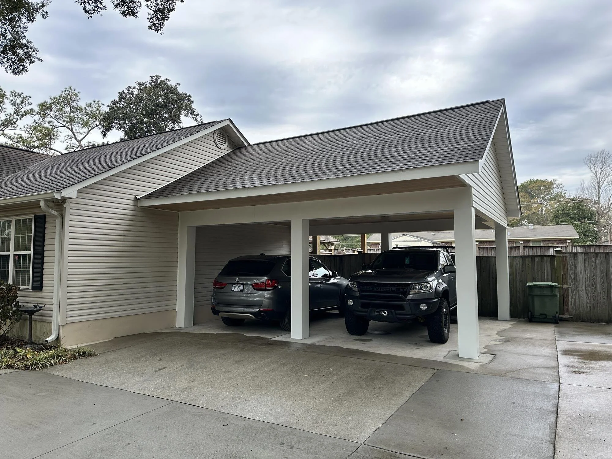 After — the finished carport with its roofline matched to the home