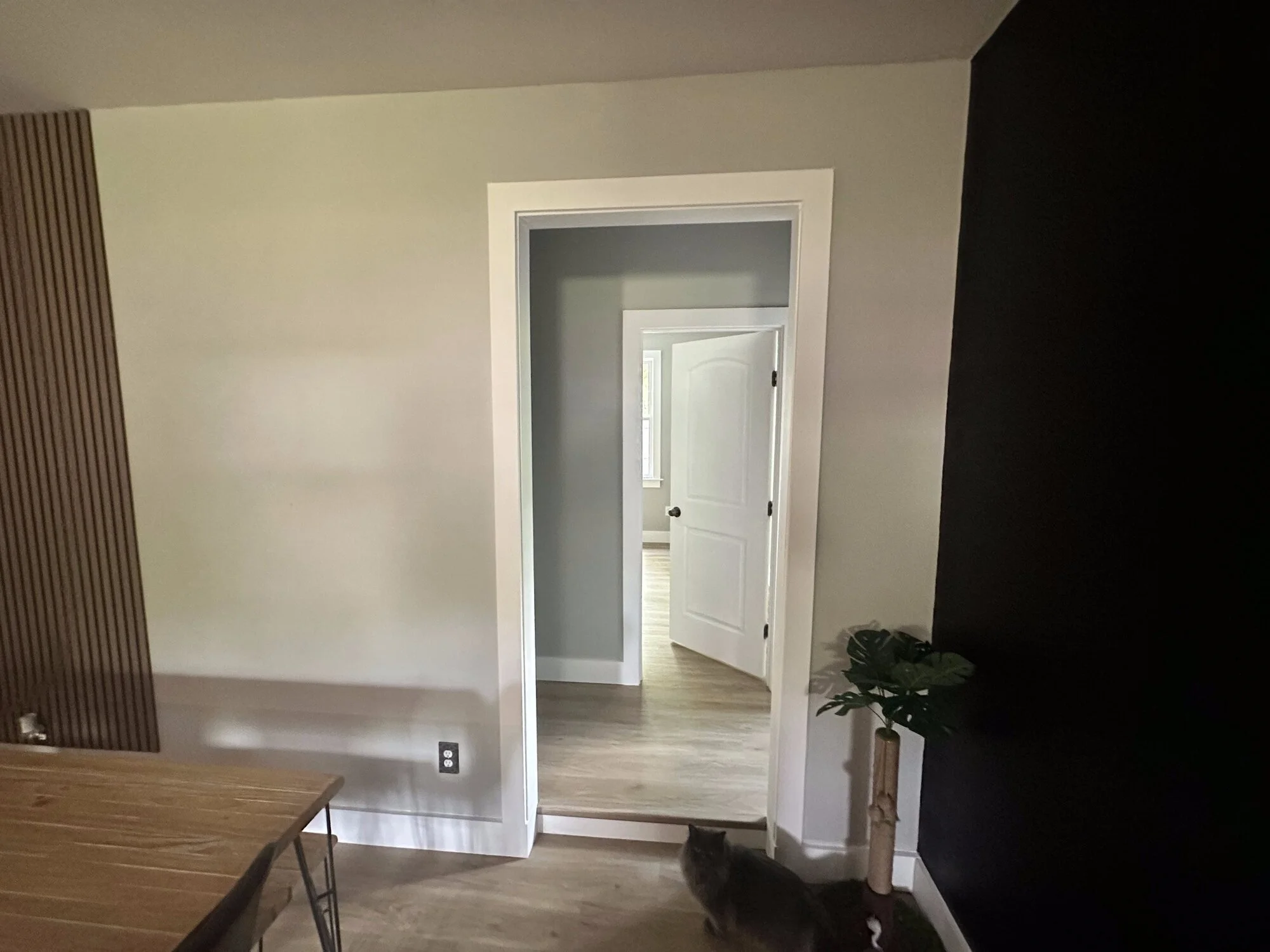 After — fresh trim, doors, and paint tying the new space to the old