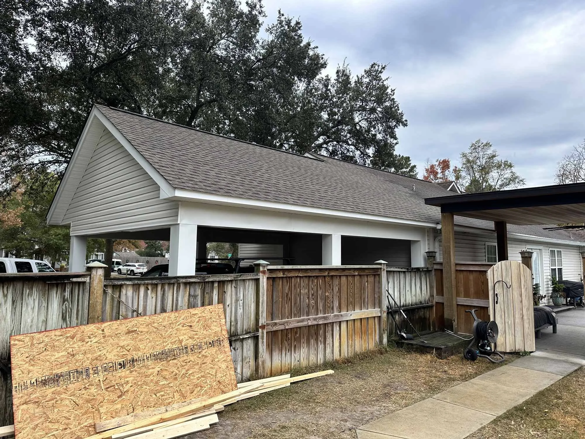During — the structure framed and sheathed, tied into the house