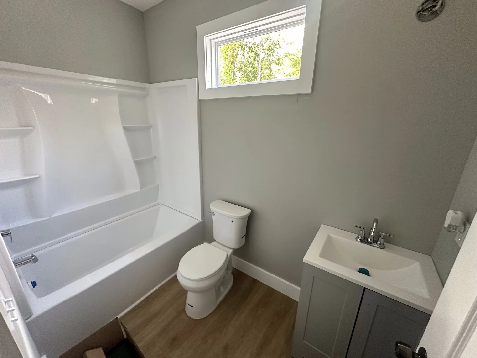 After — new full bathroom with practical tub/shower and natural light