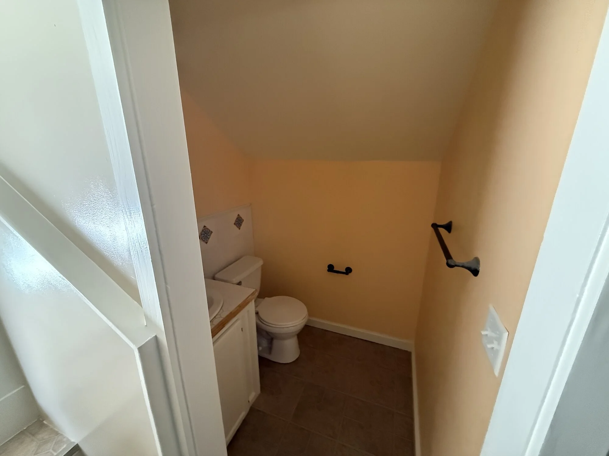 Before — cramped upstairs half bath with carpet and dated fixtures