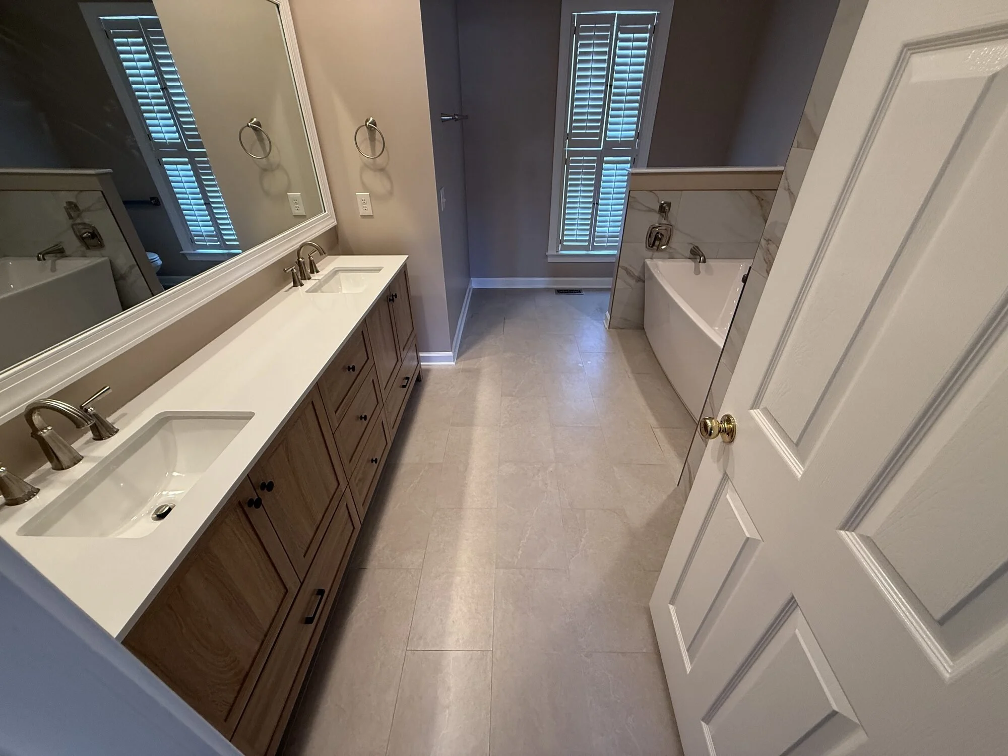 After — the full suite: new vanity, new layout, new tub alcove at the end