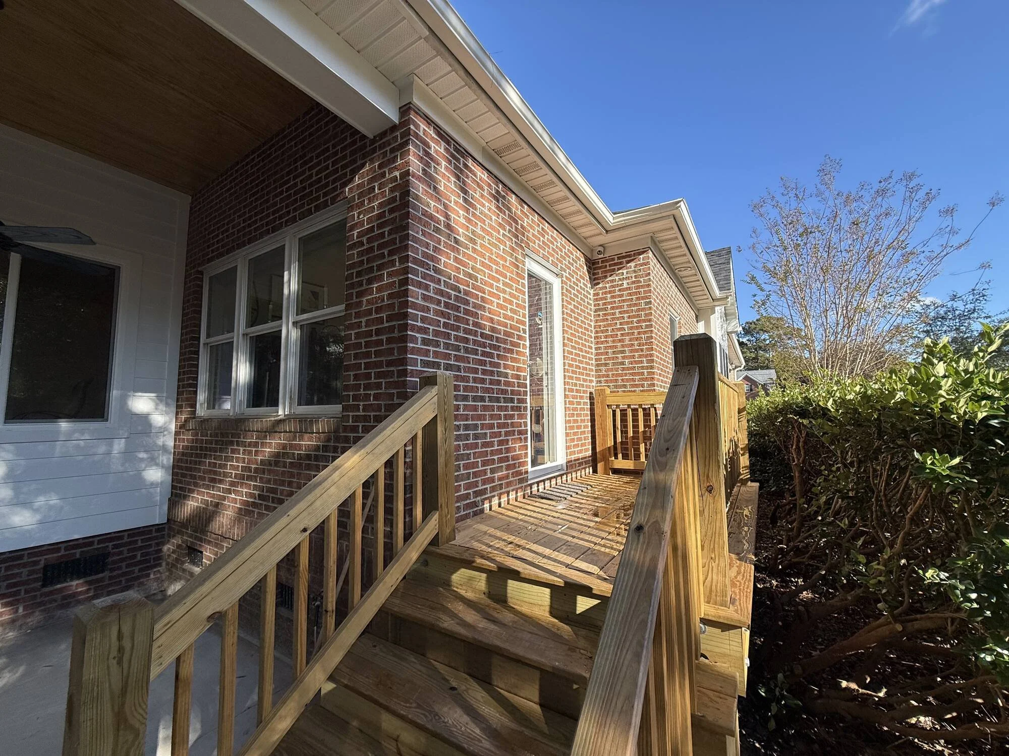 After — new door, deck and stair framing tying into the brick
