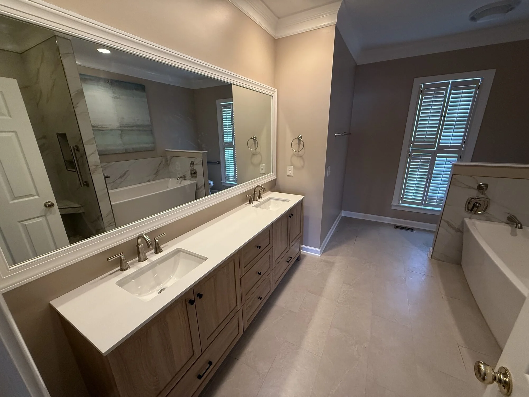 After — the vanity wall with plantation shutters letting in soft light