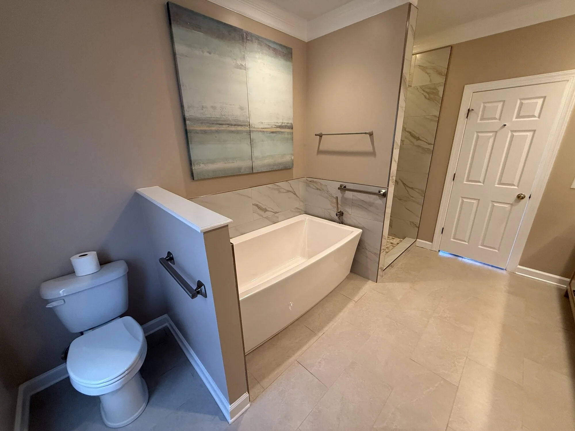 After — the new tub alcove wrapped in tile from floor to ceiling