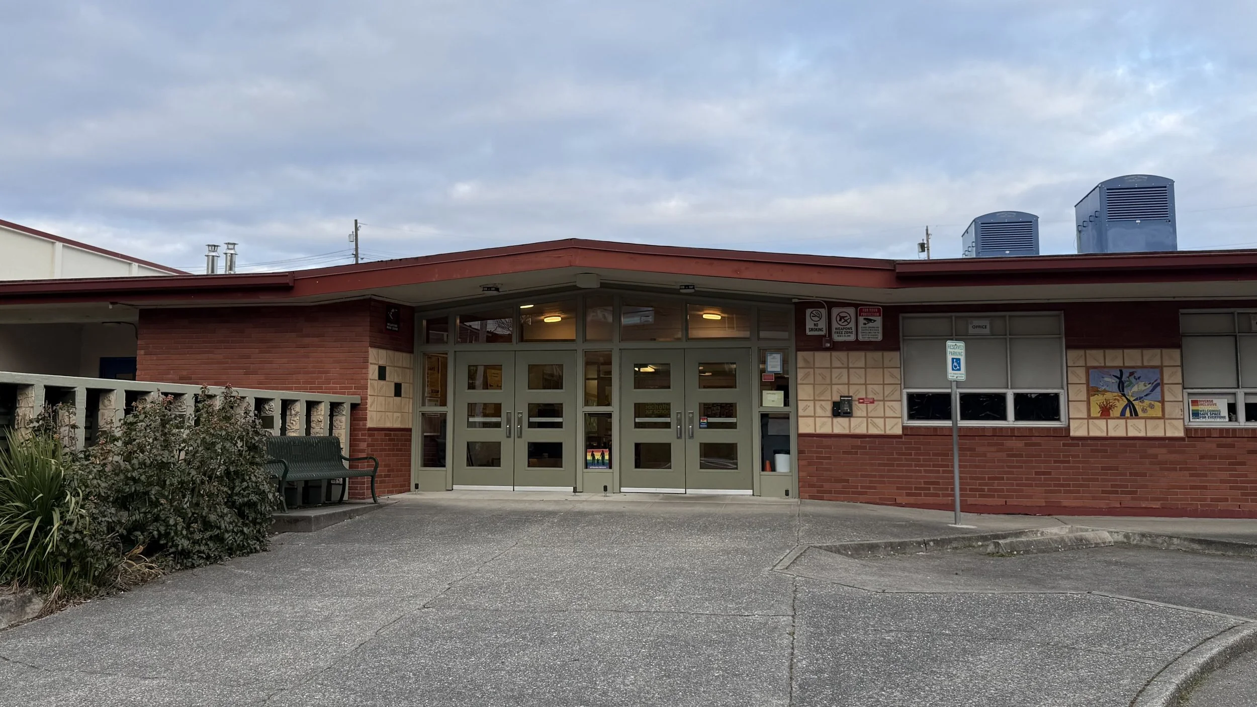 North Beach Elementary in Seattle. A low, mid-century building, with two sets of green front doors.