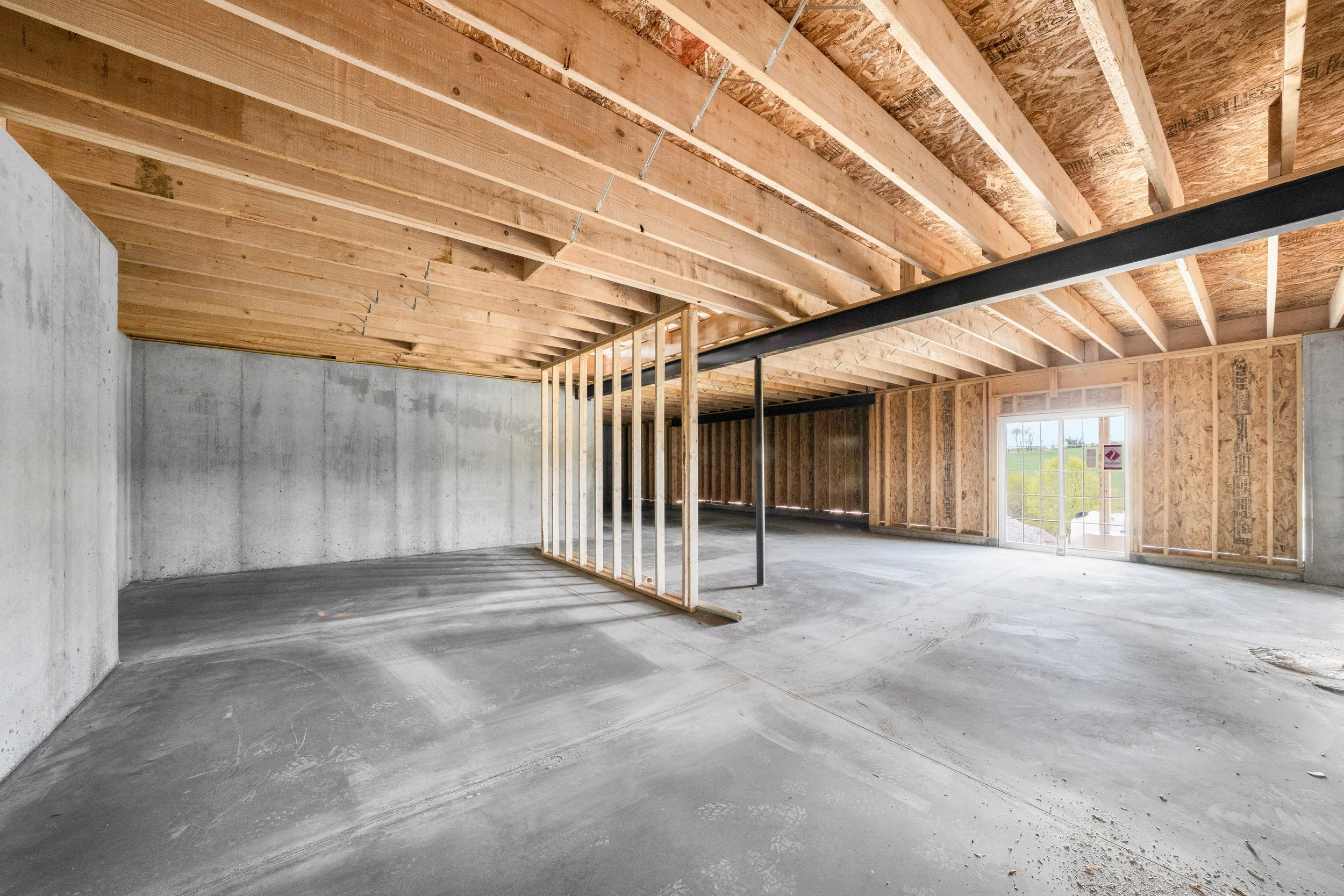Poured concrete foundation in framed home with walk out basement