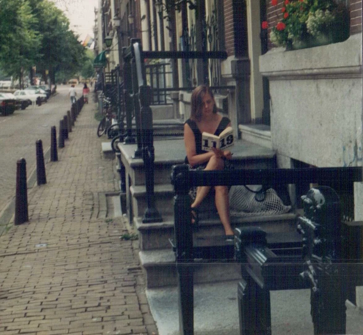 Barb reading a book by Robert Creeley in Amsterdam, 1994.