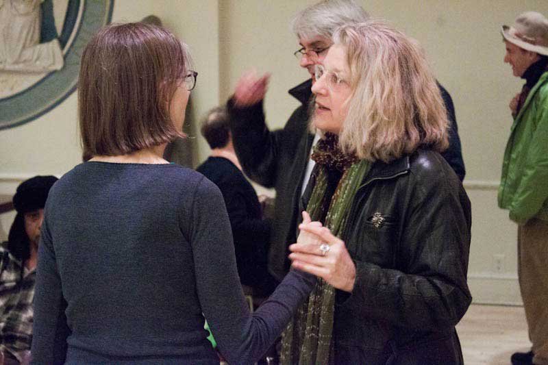 Barbara Henning and Laurie Price with John Godfrey and Cliff Fyman in the background, at Barb's reading at The Poetry Project, photo by Mook, February 29, 2012.