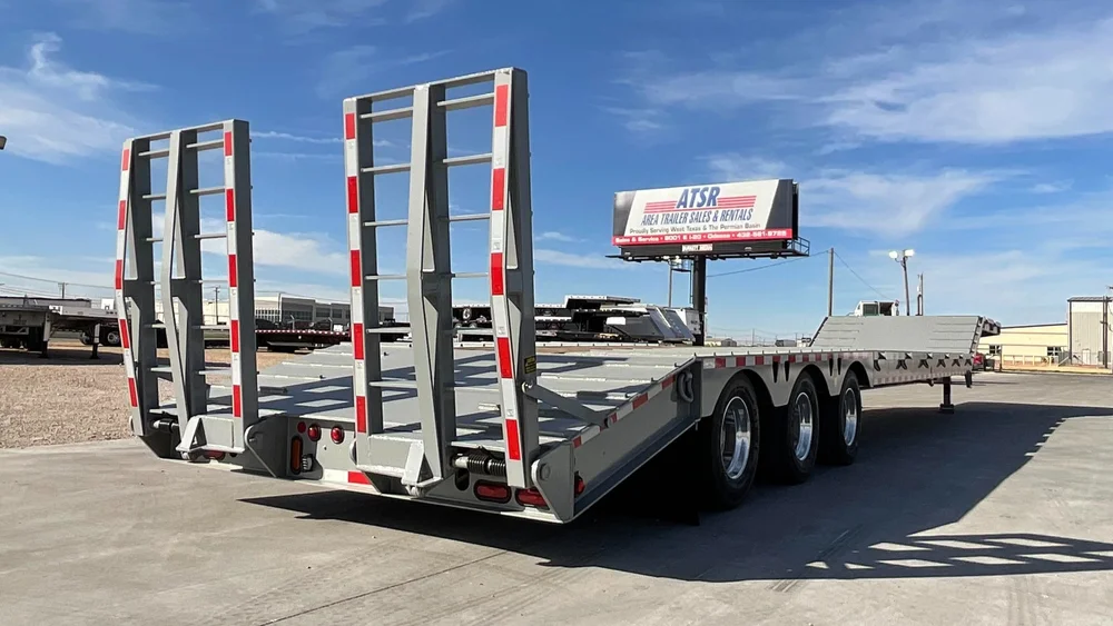 Equipment lowboy trailer with loading ramps