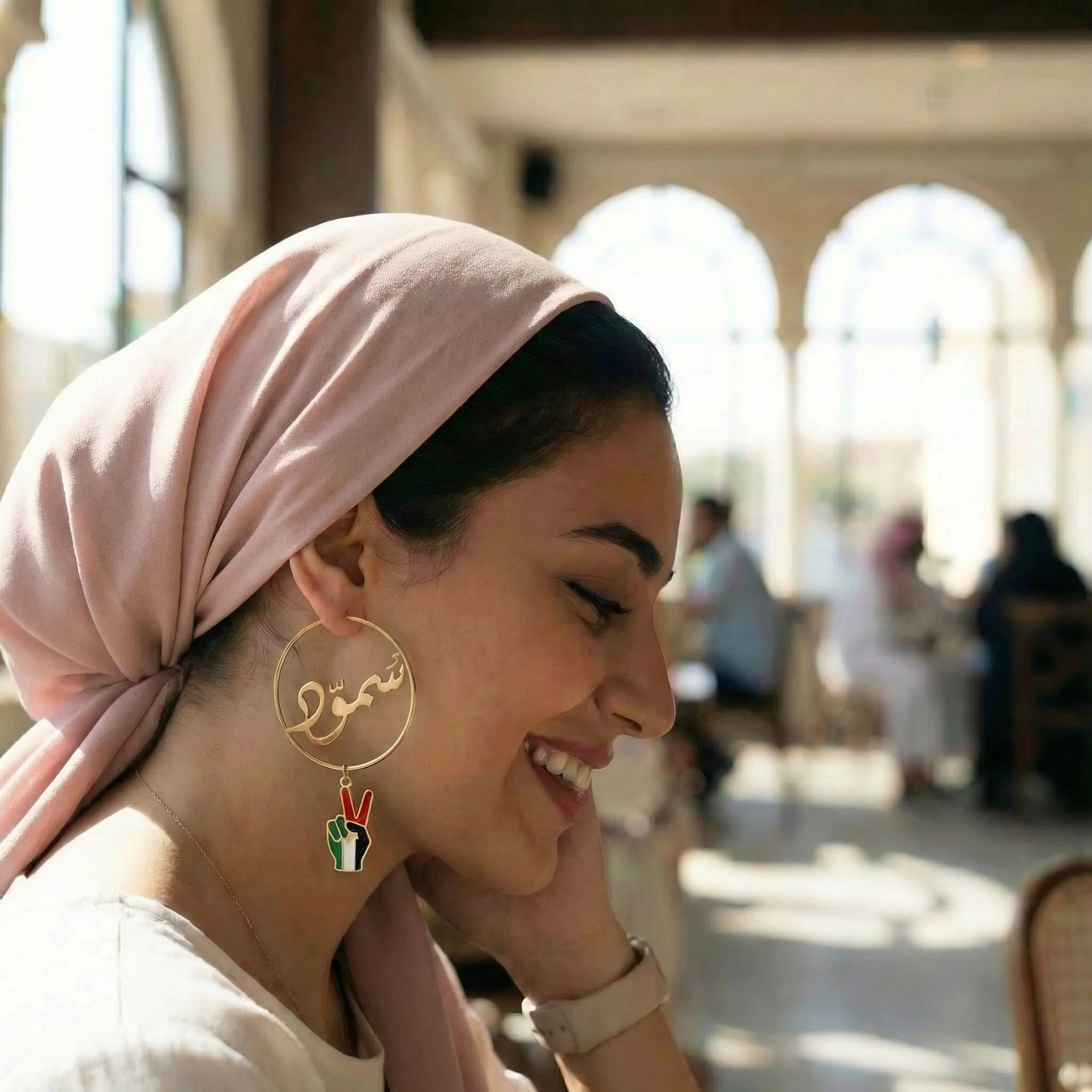 This is the second of a series where our values are translated as wearable and modern jewelry. This piece centers the Arabic word "Sumud" meaning "to persevere" with the symbolic peace fingers in enamel dangling below. Words and action together in ha