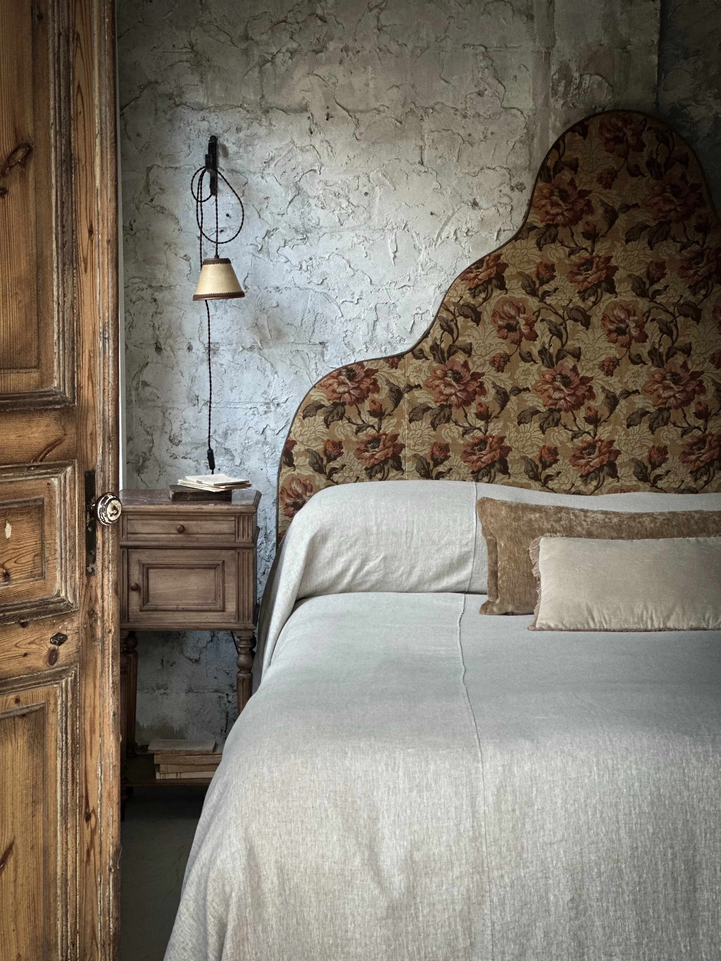 A truly one-of-a-kind king bedhead, upholstered by us using  antique brocade sourced in Paris. Once grand curtains in a French home, this beautiful textile now brings timeless elegance and history to its striking curved silhouette. Thoughtfully uphol