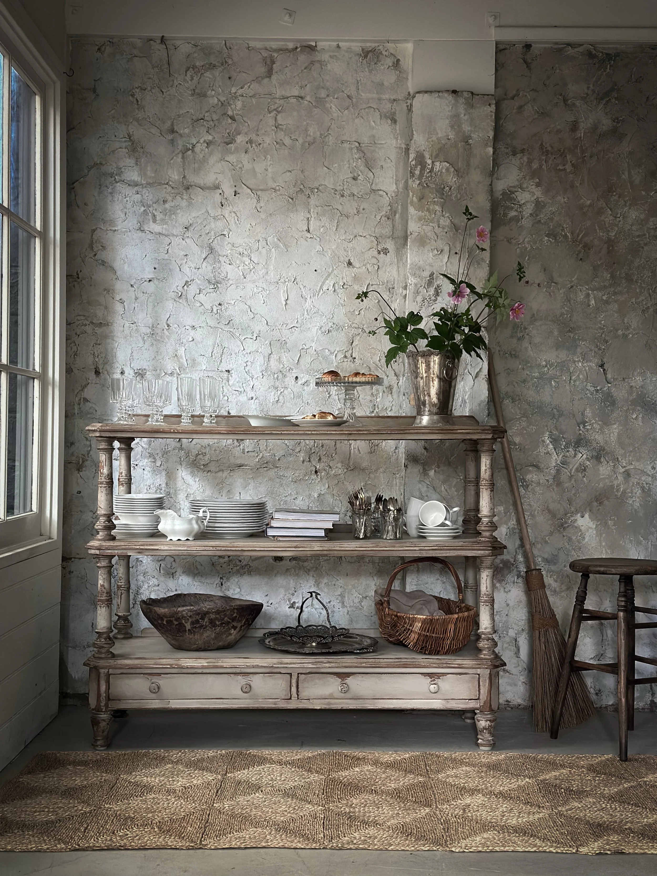 A beautiful vintage servery, gently painted and aged in our antique finish to bring out its natural character and charm. With three open shelves, two generous drawers and delicate hand-carved details, it&rsquo;s both practical and timeless.

Perfect 