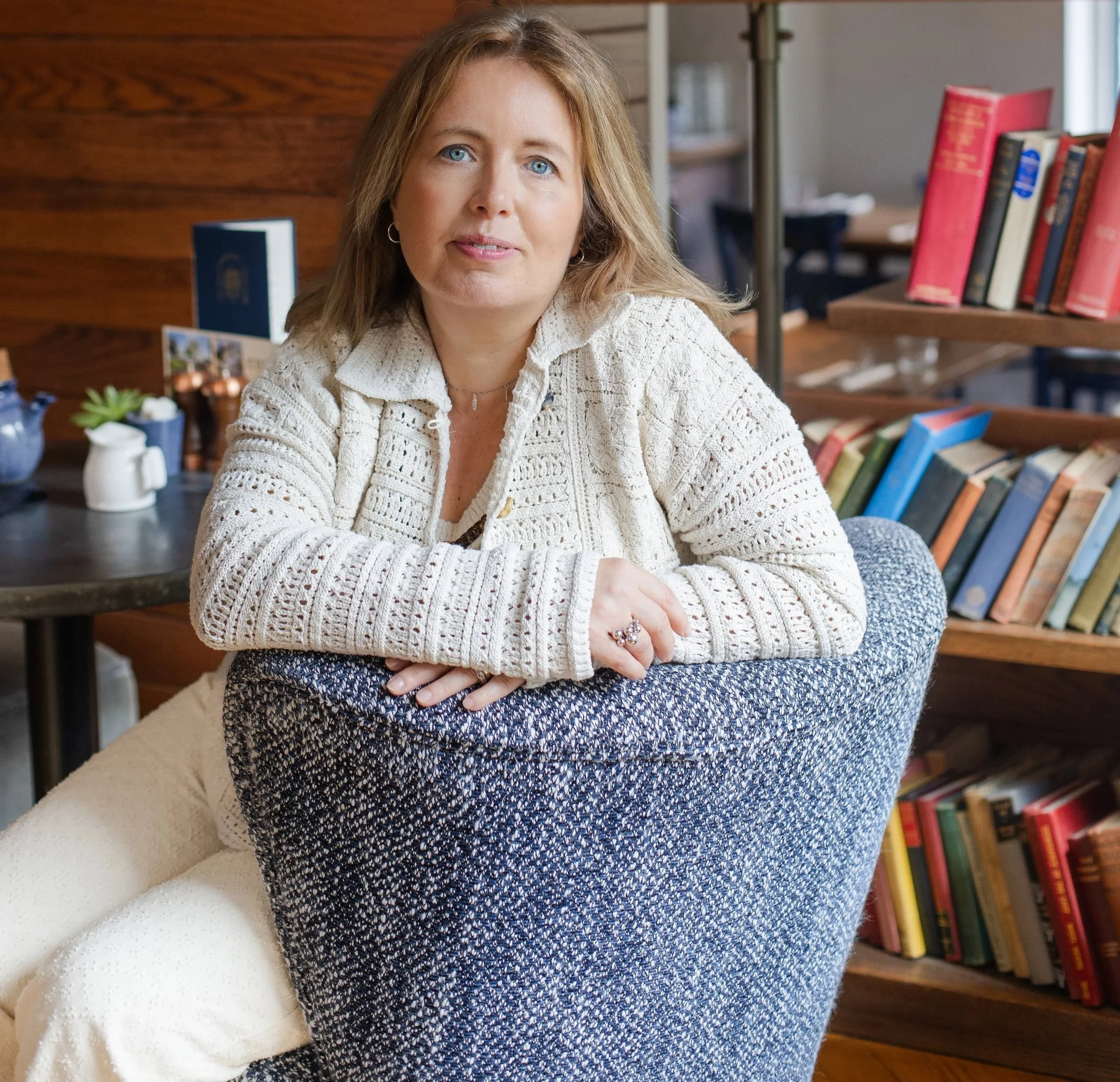 Sarah Robinson, founder of Mindful & Me, smiling while seated in a cosy café.
