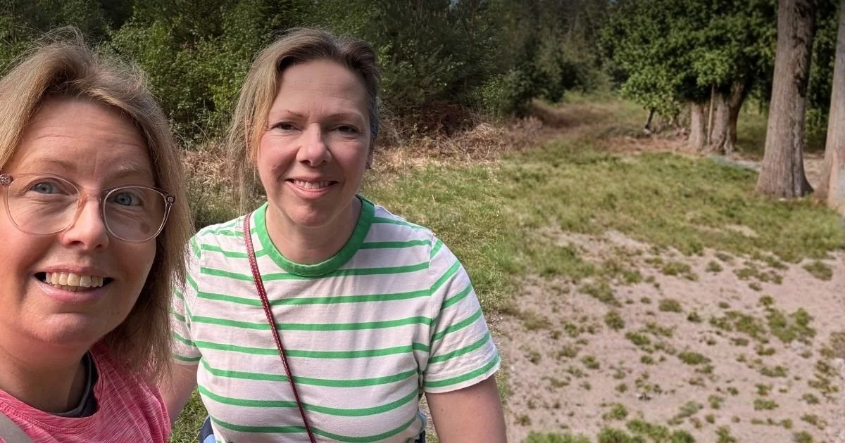 Sarah and Faye smiling at camera whilst on Menopause Walk in Swinley Forest, Bracknell, Berkshire.