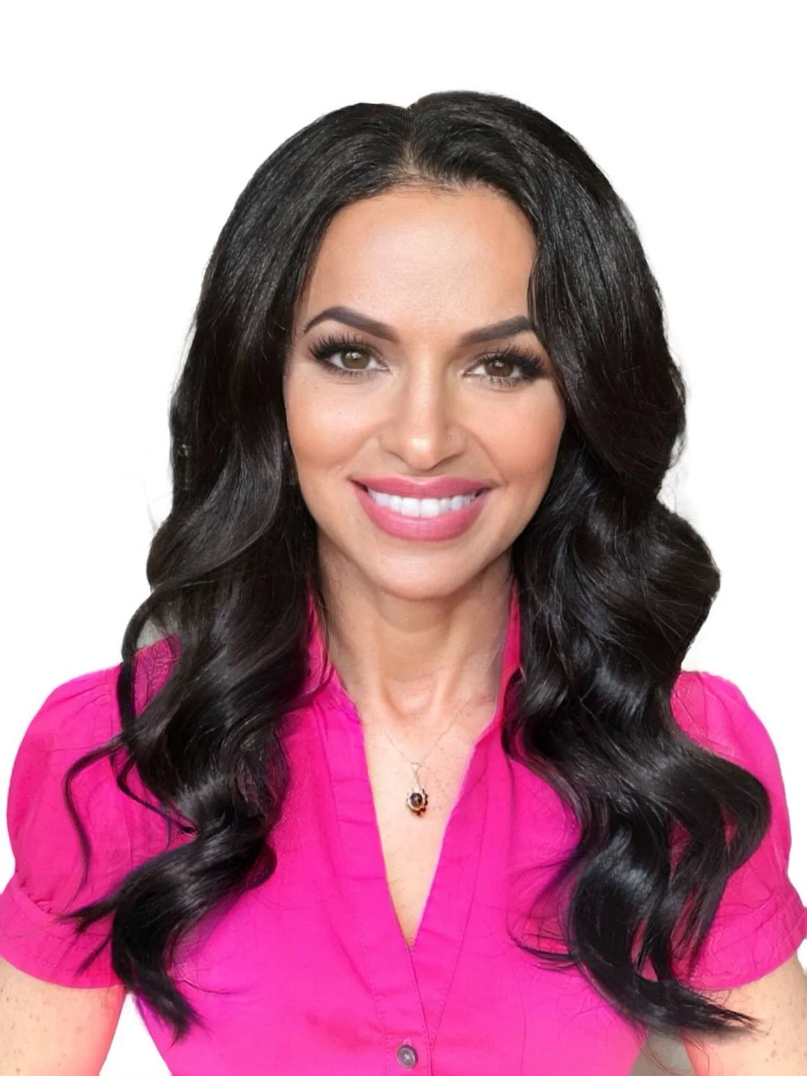 Woman with long dark hair, wearing a pink shirt and necklace, smiling at the camera.