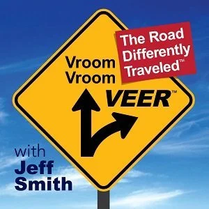 Podcast cover art featuring a yellow road sign with arrows indicating a veer, accompanied by text "Vroom Vroom VEER," "The Road Differently Traveled," and "with Jeff Smith."