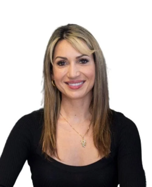 Person with long hair and black top smiling against white background